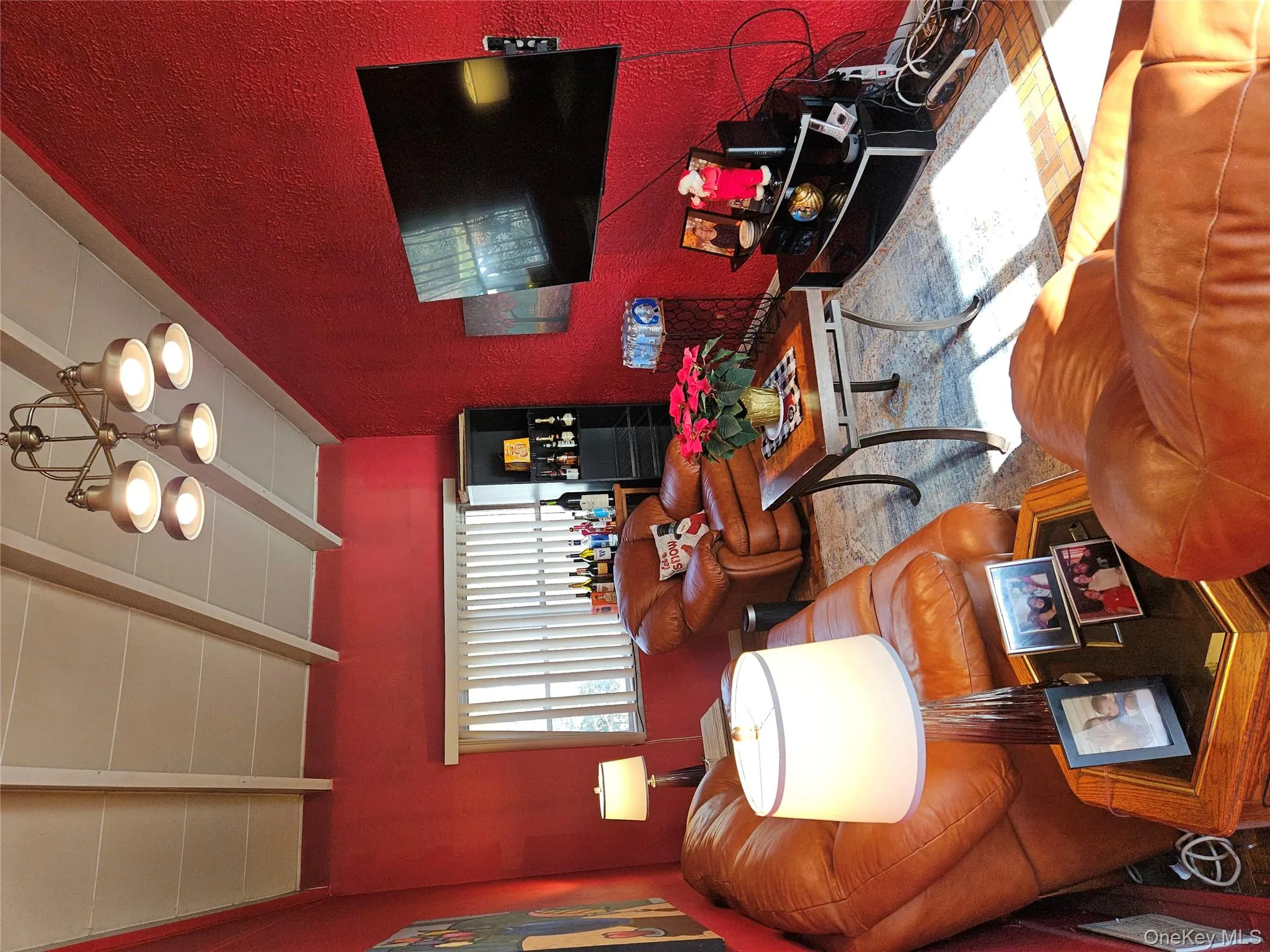 Living area with a textured wall and a chandelier Living area with a textured wall and a chandelier