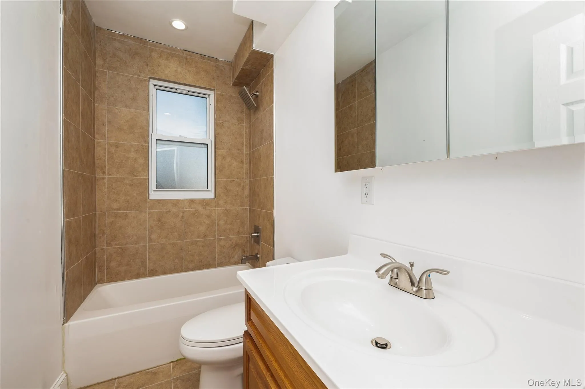 Full bathroom with shower / bathtub combination, vanity, and light tile patterned floors Full bathroom with shower / bathtub combination, vanity, and light tile patterned floors
