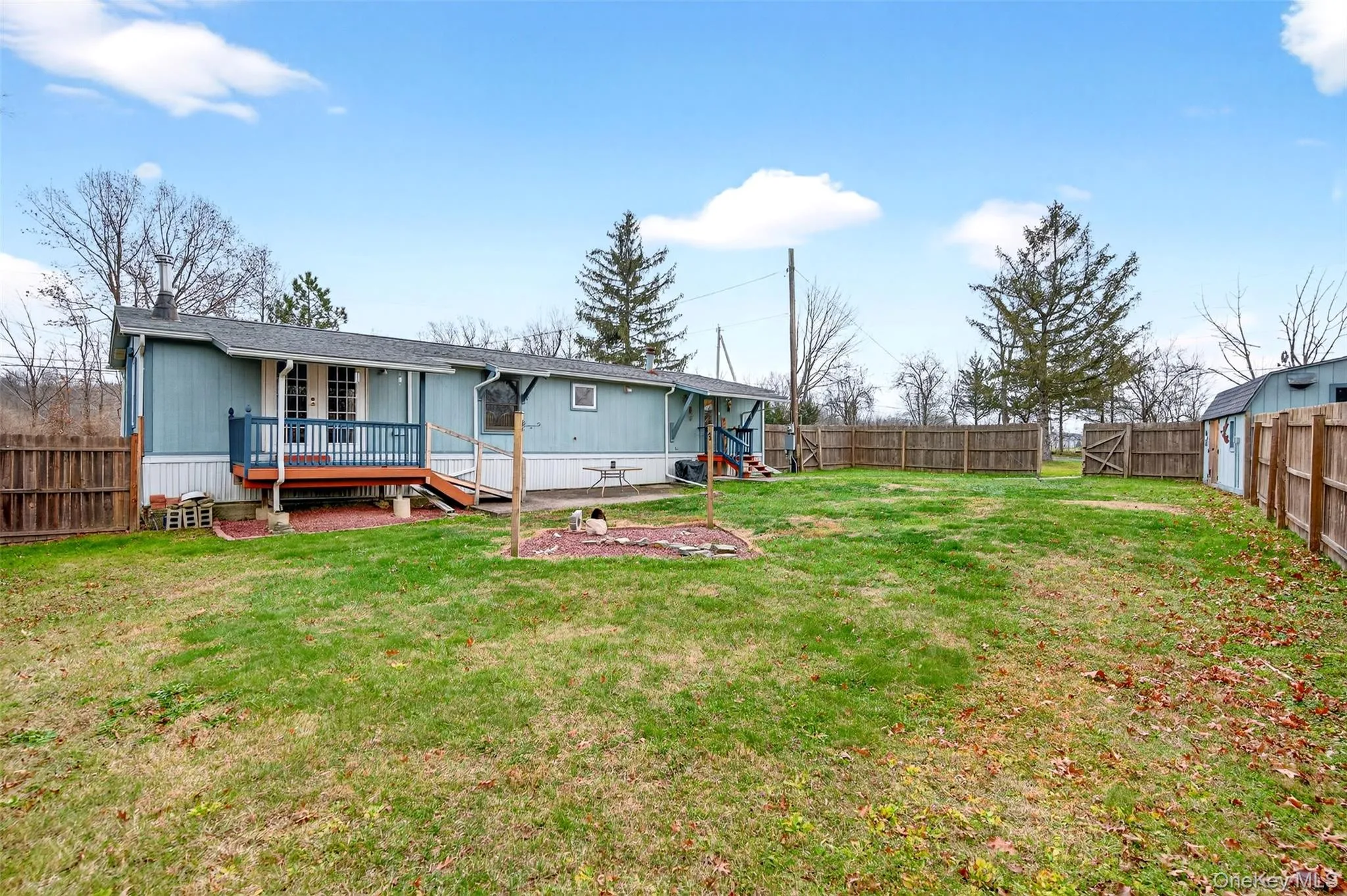 Back of house featuring a fenced backyard and a deck Back of house featuring a fenced backyard and a deck