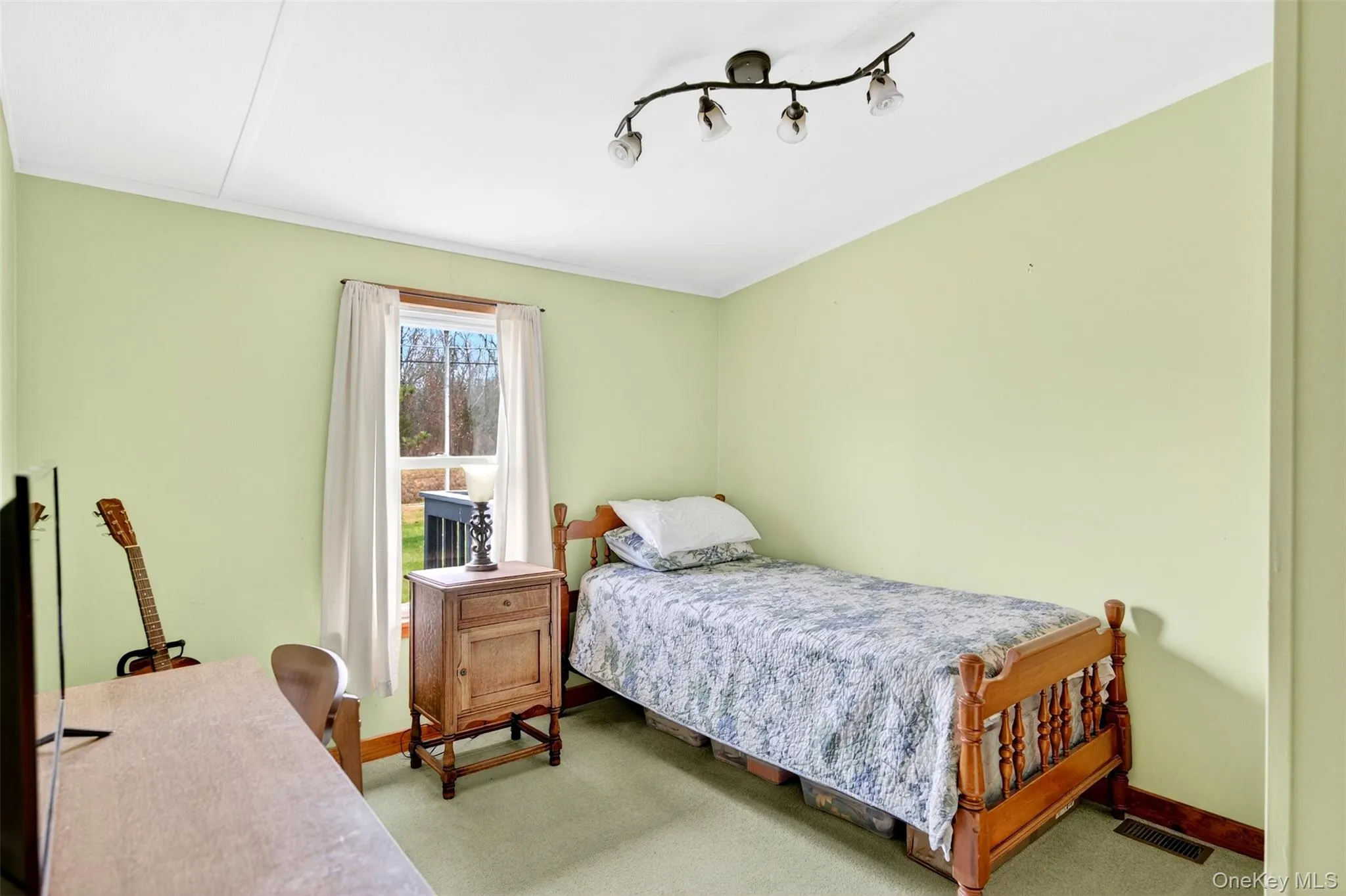Bedroom featuring carpet floors and a desk Bedroom featuring carpet floors and a desk