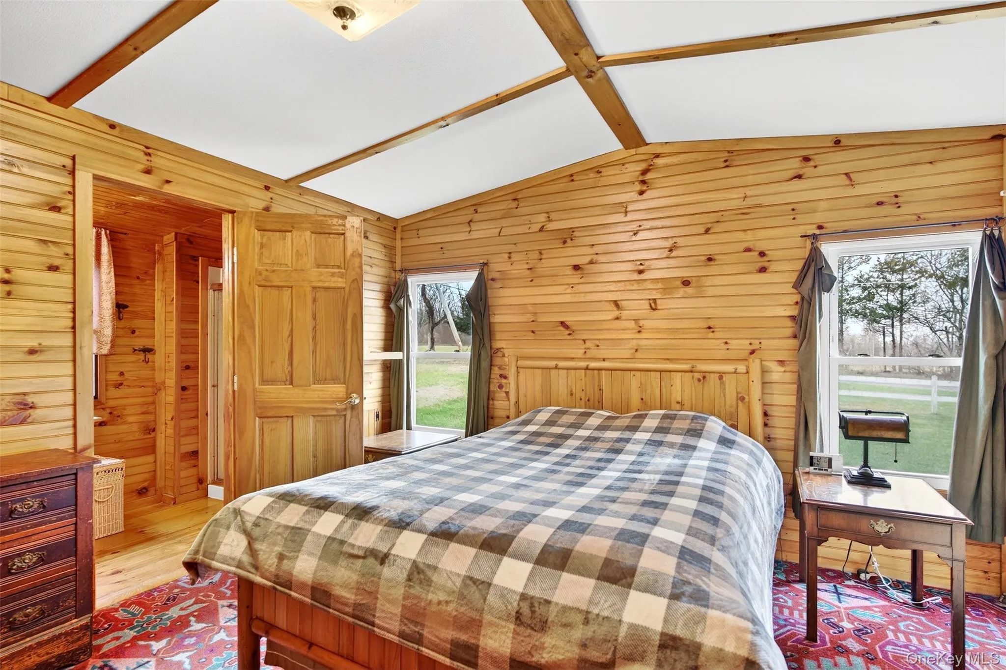 Bedroom with wood finished floors and wood walls Bedroom with wood finished floors and wood walls