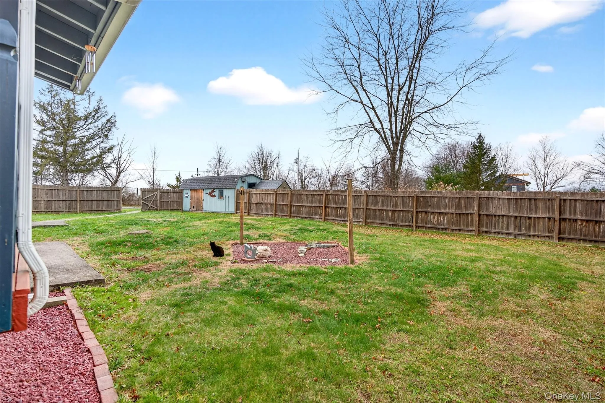 Fenced backyard with a shed Fenced backyard with a shed