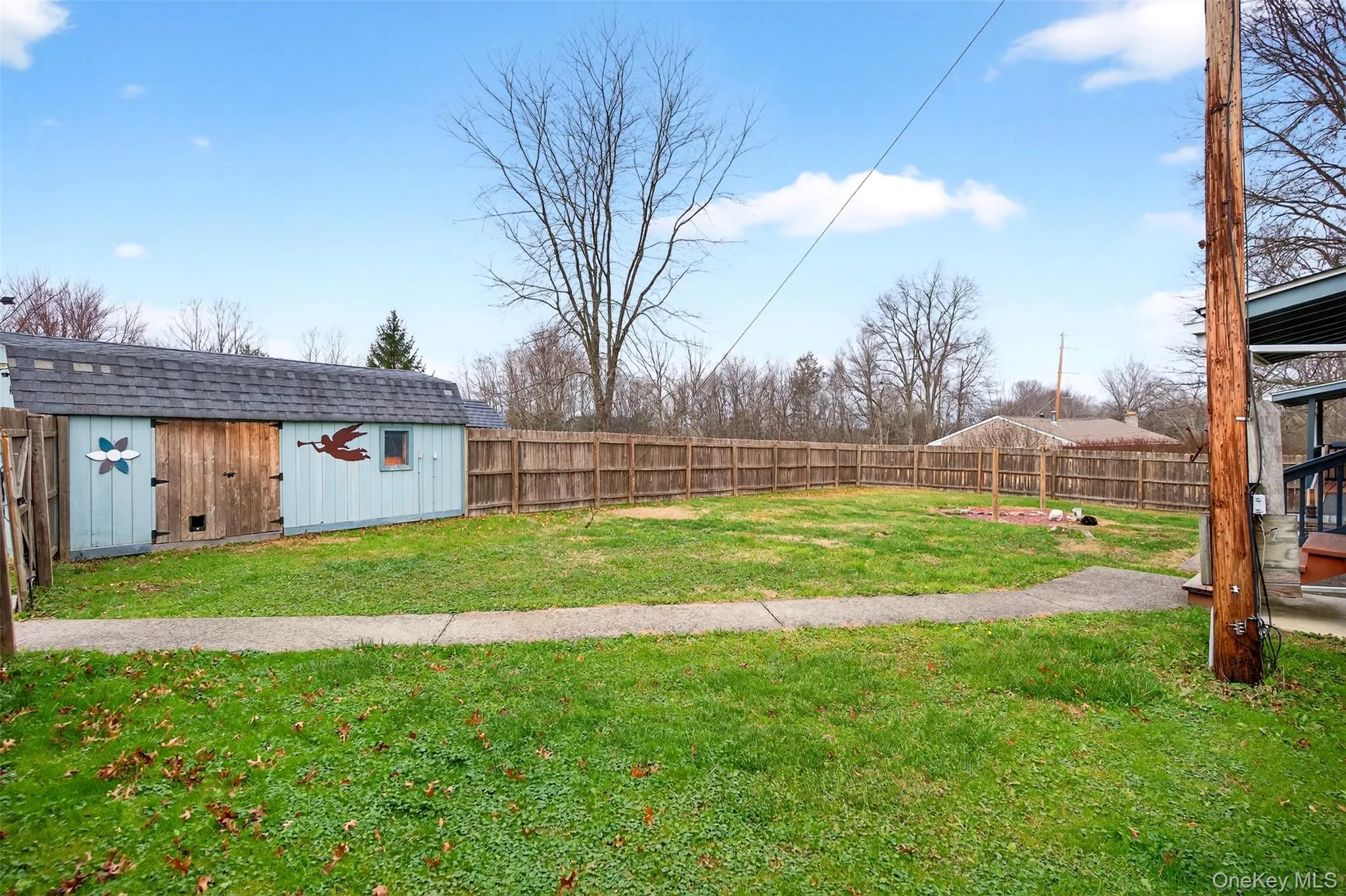 Fenced backyard featuring an outbuilding Fenced backyard featuring an outbuilding
