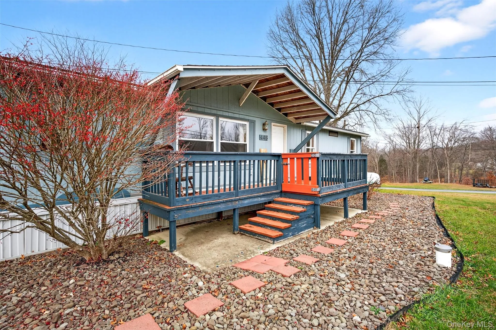 View of front facade with a wooden deck View of front facade with a wooden deck