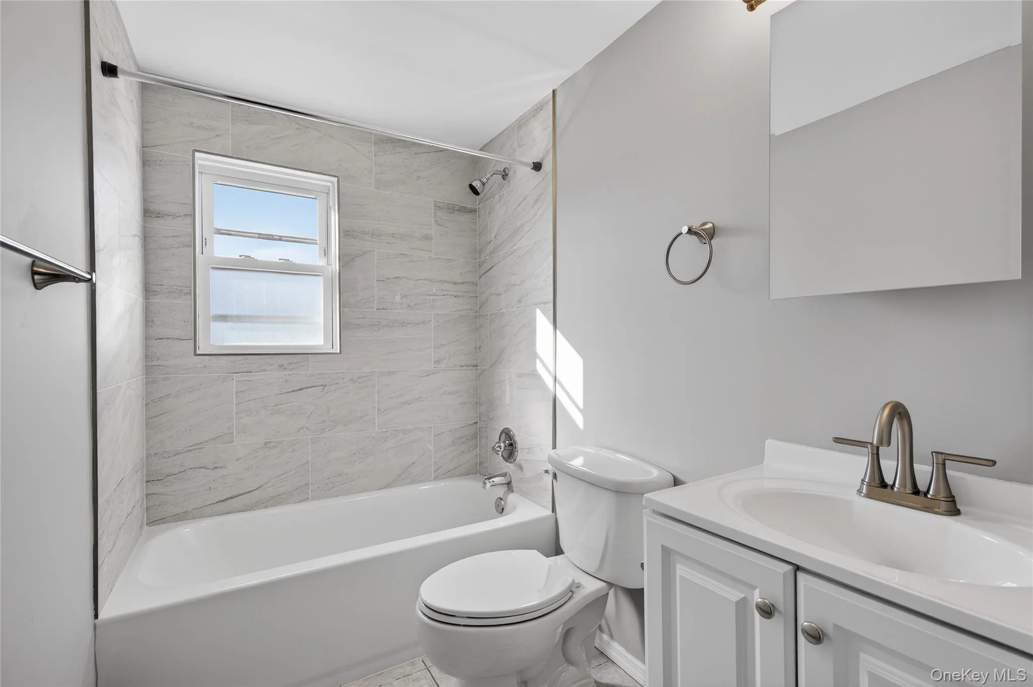 Bathroom with bathing tub / shower combination and vanity Bathroom with bathing tub / shower combination and vanity