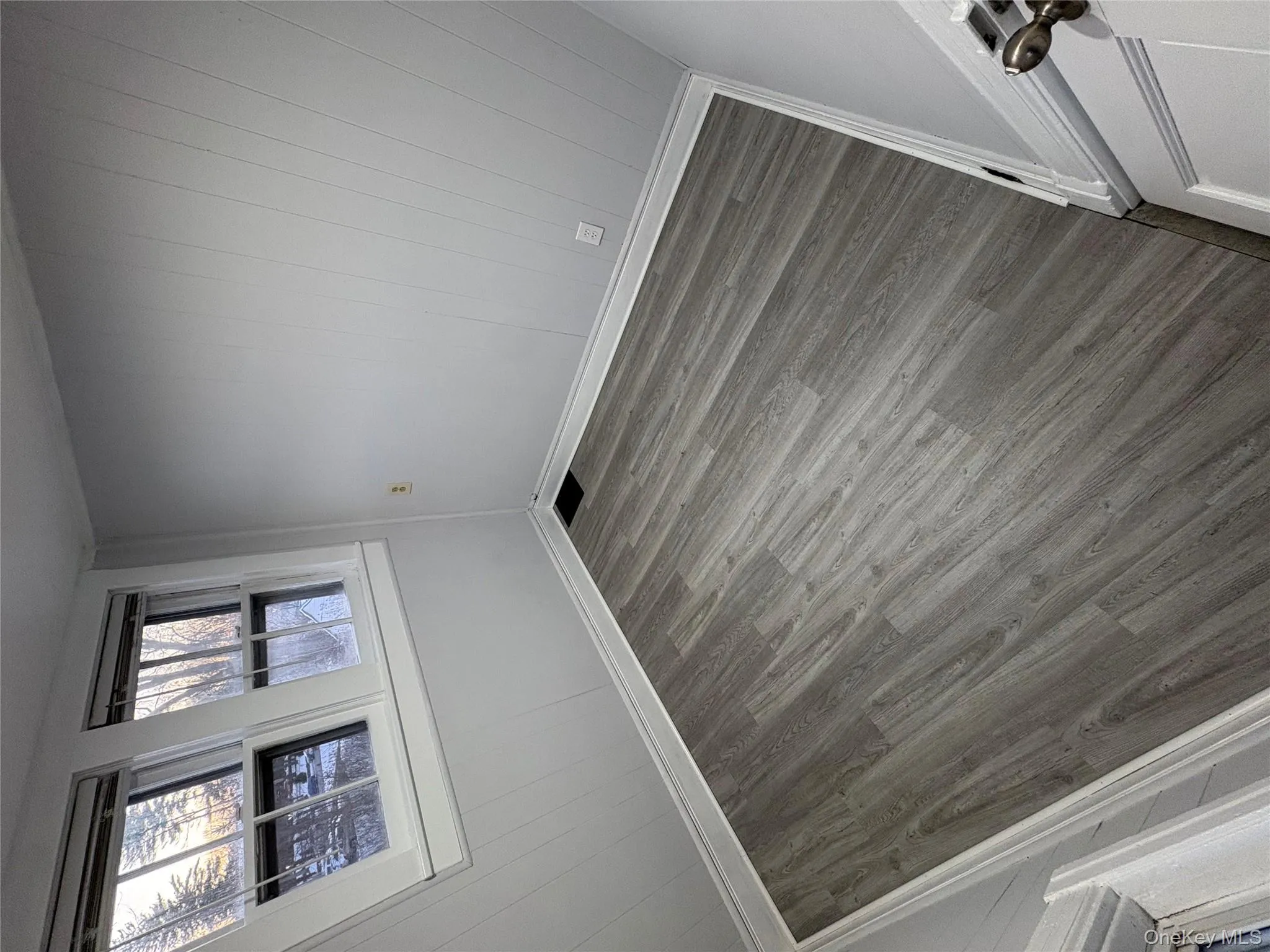 Empty room with wooden walls and wood finished floors Empty room with wooden walls and wood finished floors