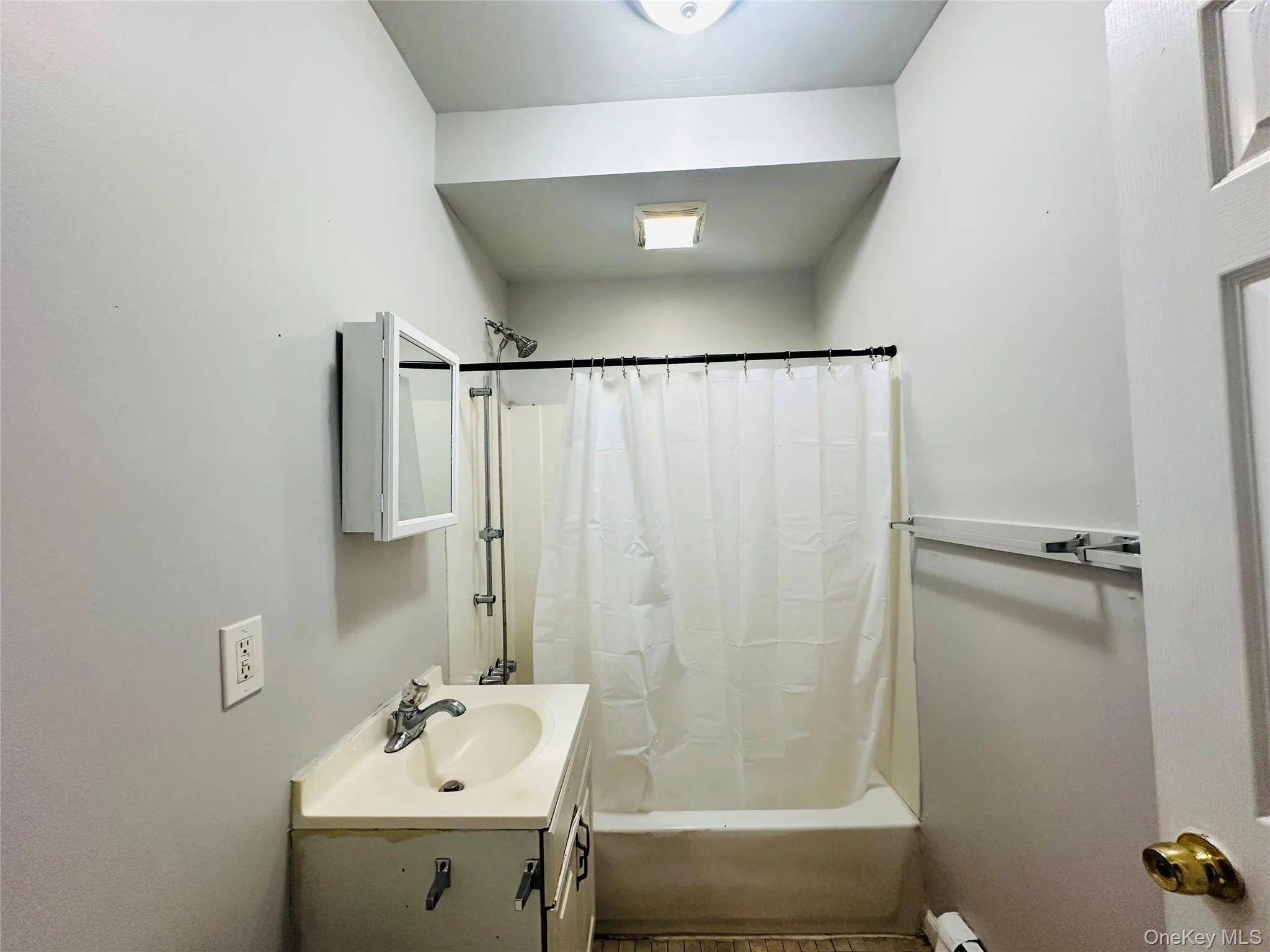 Full bathroom featuring vanity and shower / tub combo with curtain Full bathroom featuring vanity and shower / tub combo with curtain