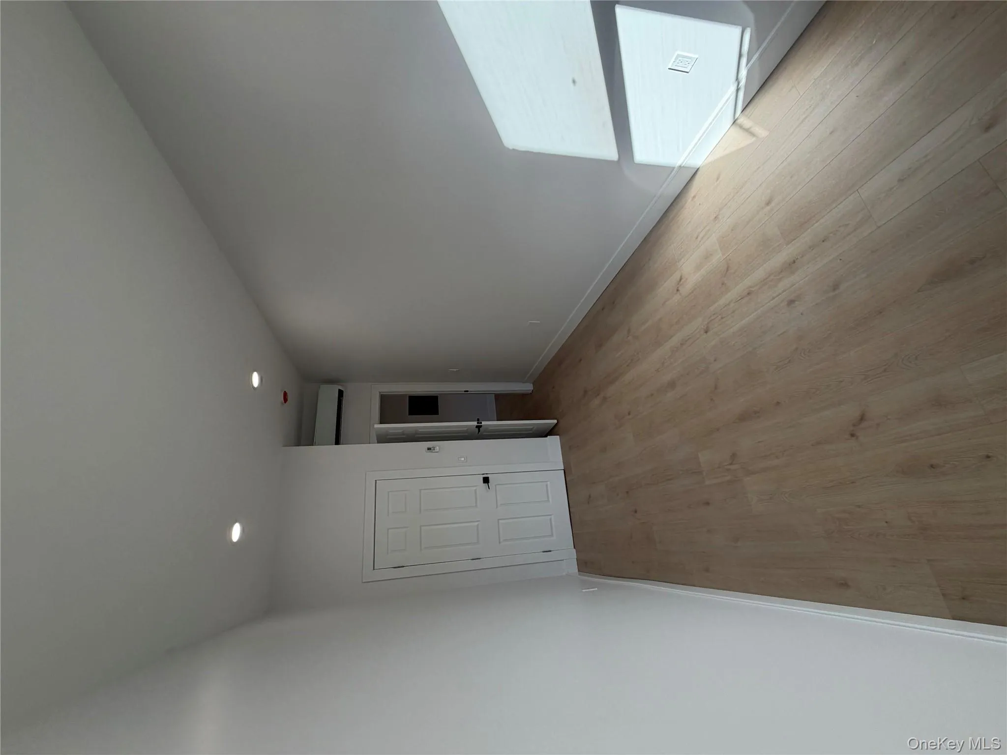 Unfurnished bedroom featuring light wood-style floors, recessed lighting, and a wall unit AC Unfurnished bedroom featuring light wood-style floors, recessed lighting, and a wall unit AC