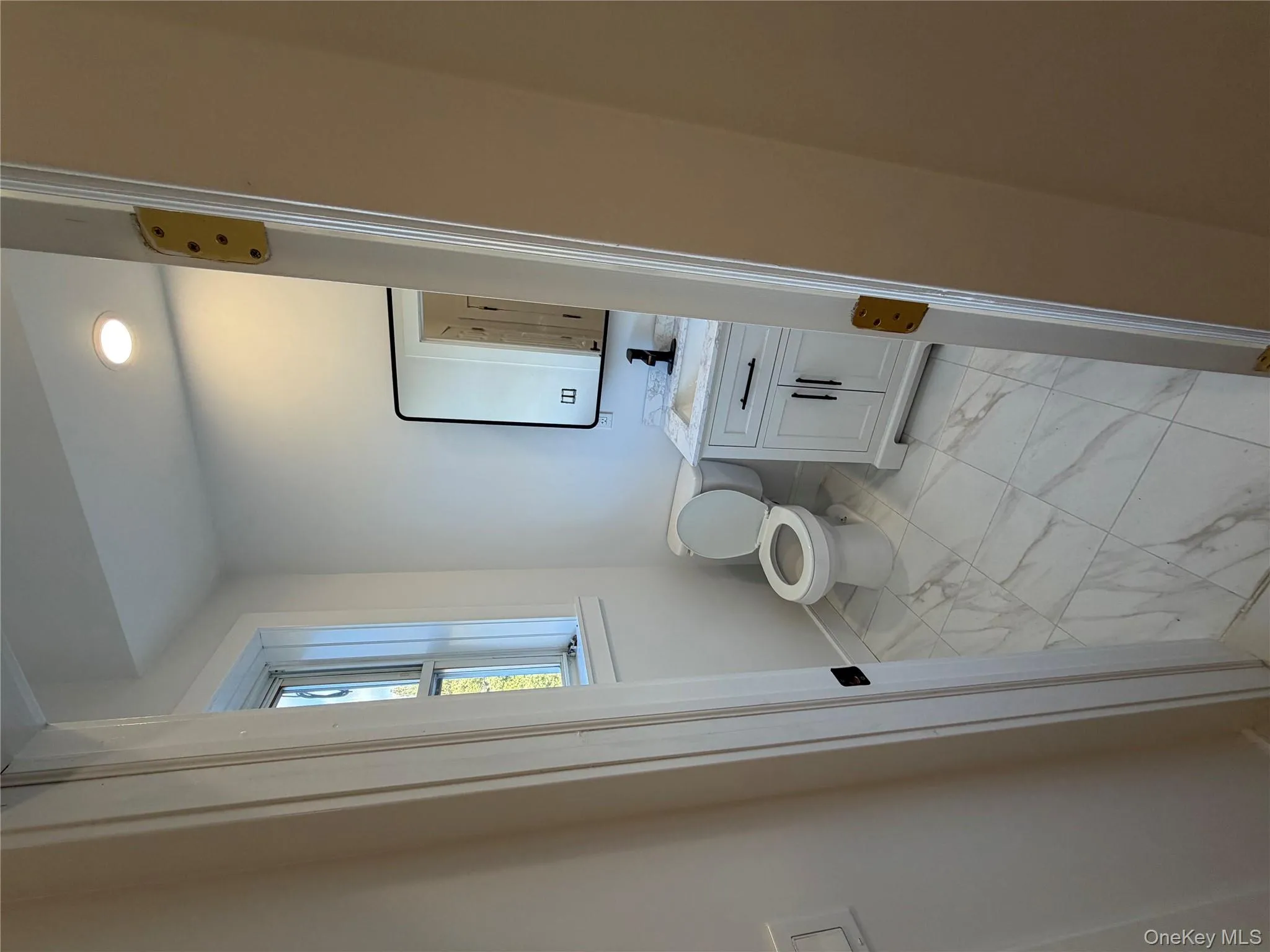 Half bath with light marble finish flooring, vanity, and recessed lighting Half bath with light marble finish flooring, vanity, and recessed lighting