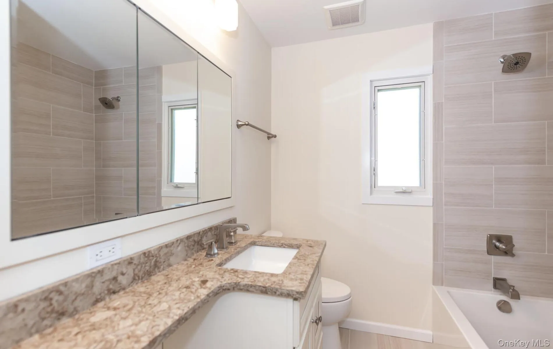 Full bathroom with vanity and shower / bathtub combination Full bathroom with vanity and shower / bathtub combination