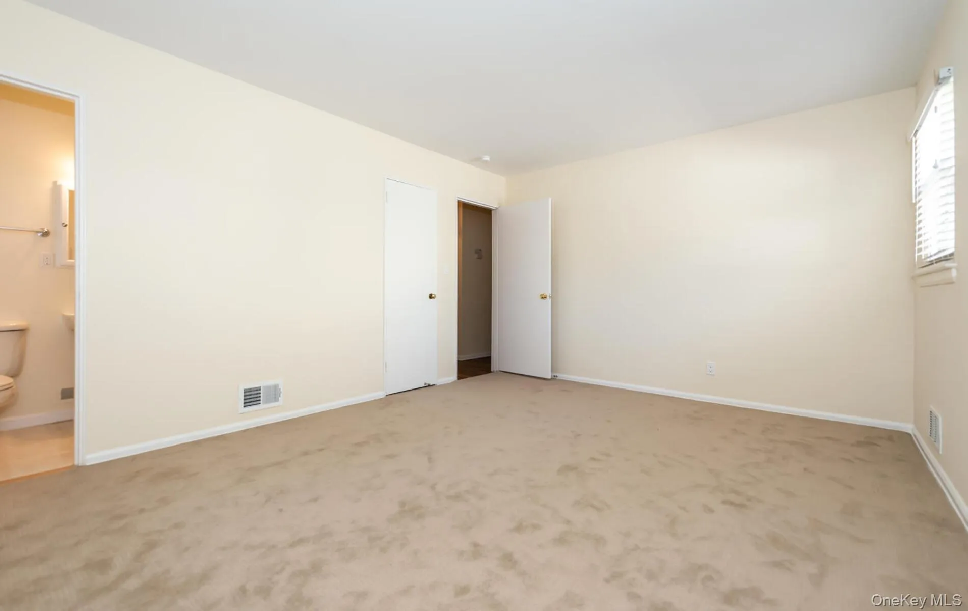 Unfurnished bedroom featuring carpet floors and baseboards Unfurnished bedroom featuring carpet floors and baseboards