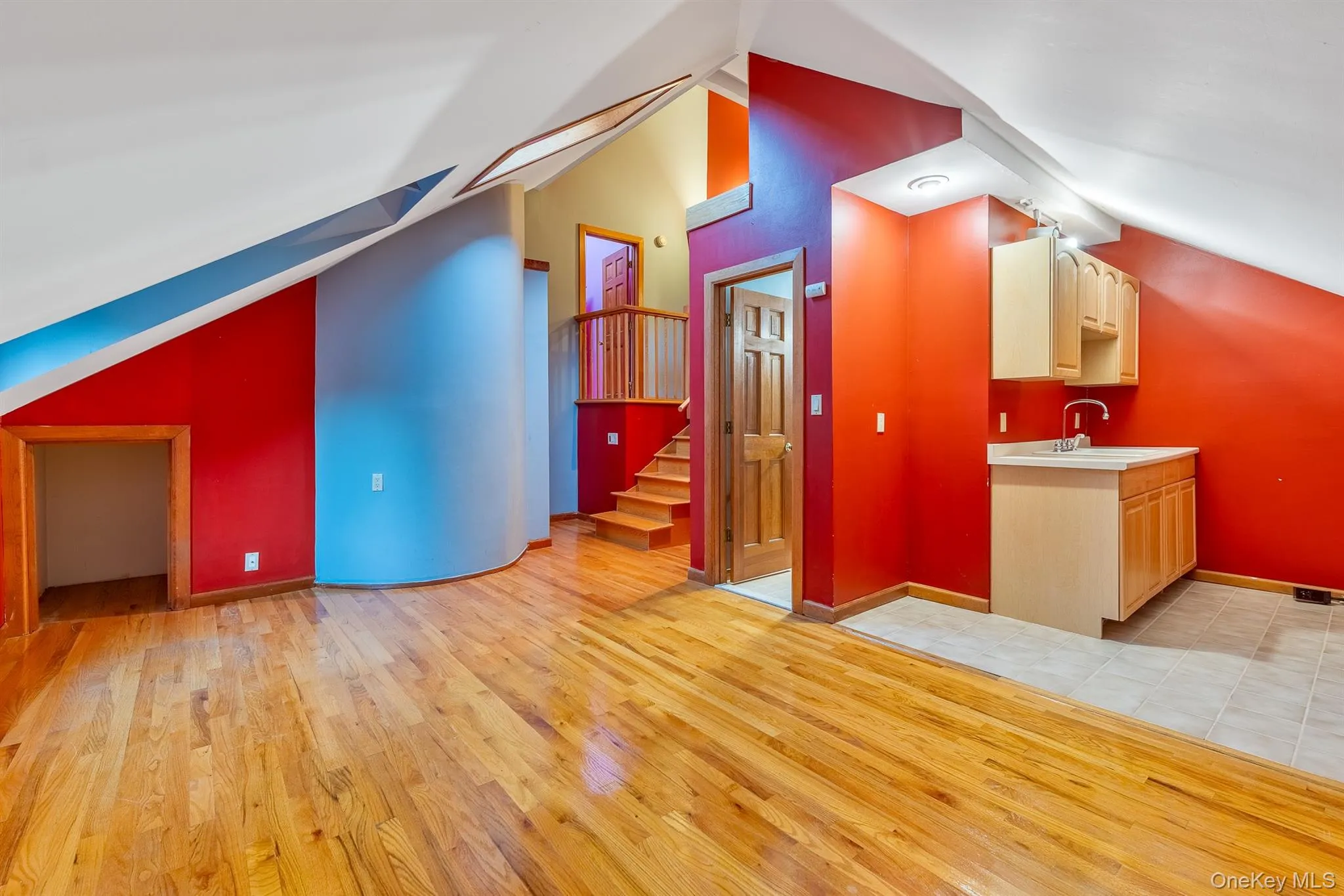 Bonus room featuring vaulted ceiling, light wood-type flooring, stairway, and a skylight Bonus room featuring vaulted ceiling, light wood-type flooring, stairway, and a skylight