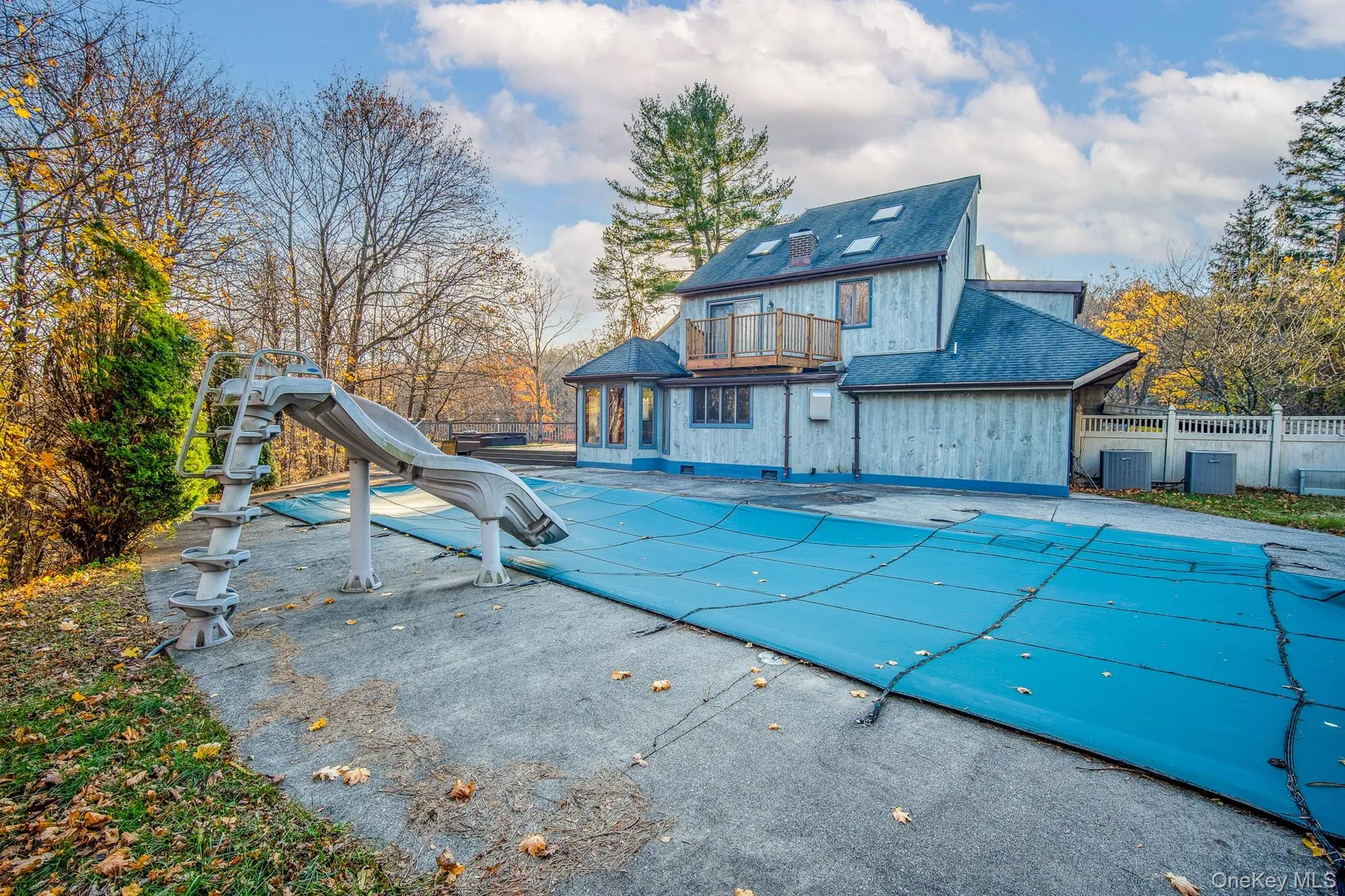 View of pool with a water slide, a balcony, and a patio View of pool with a water slide, a balcony, and a patio