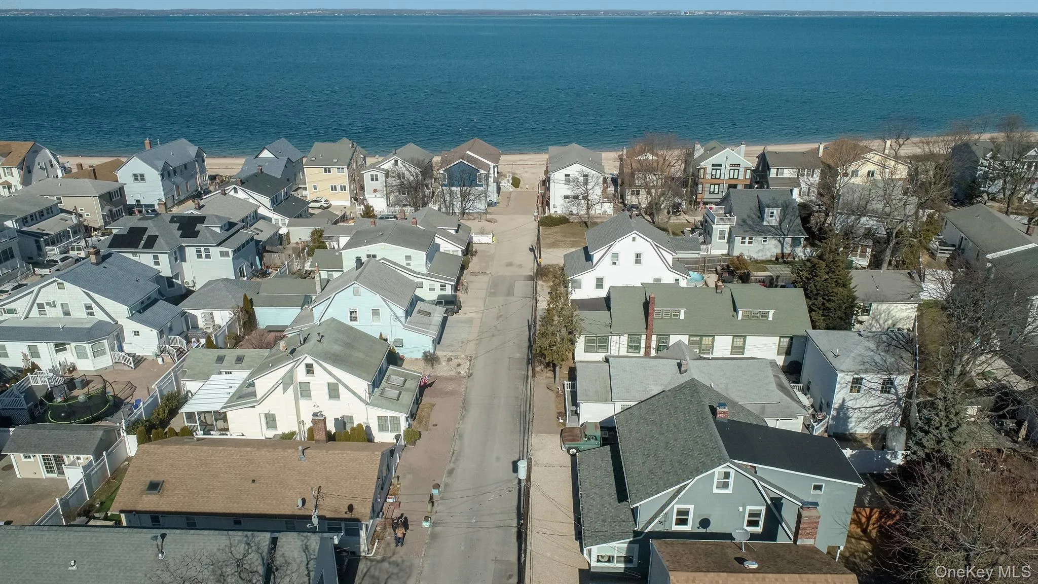 Aerial view of property's location with a nearby body of water and nearby suburban area Aerial view of property's location with a nearby body of water and nearby suburban area