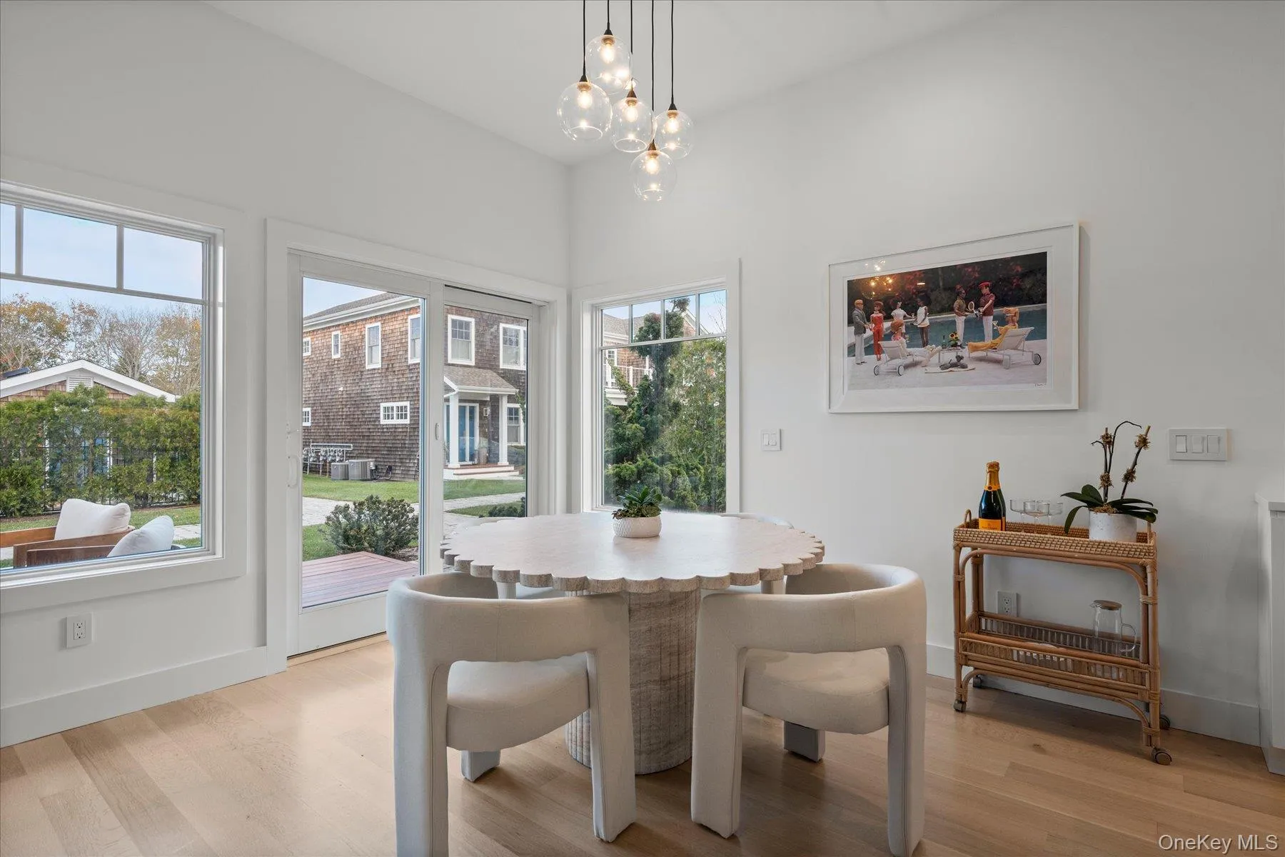 Dining room with light wood-type flooring and a chandelier Dining room with light wood-type flooring and a chandelier