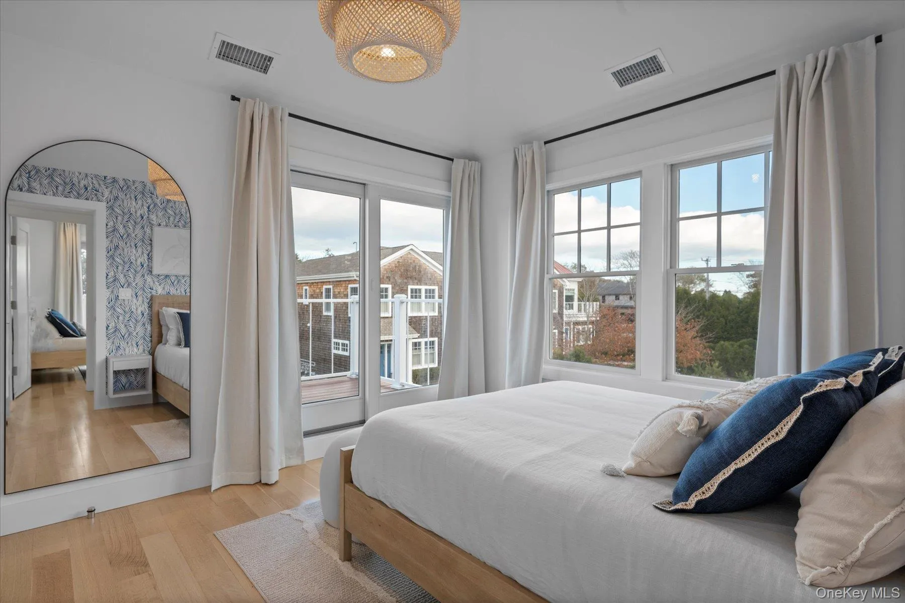 Bedroom featuring light wood finished floors and access to exterior Bedroom featuring light wood finished floors and access to exterior