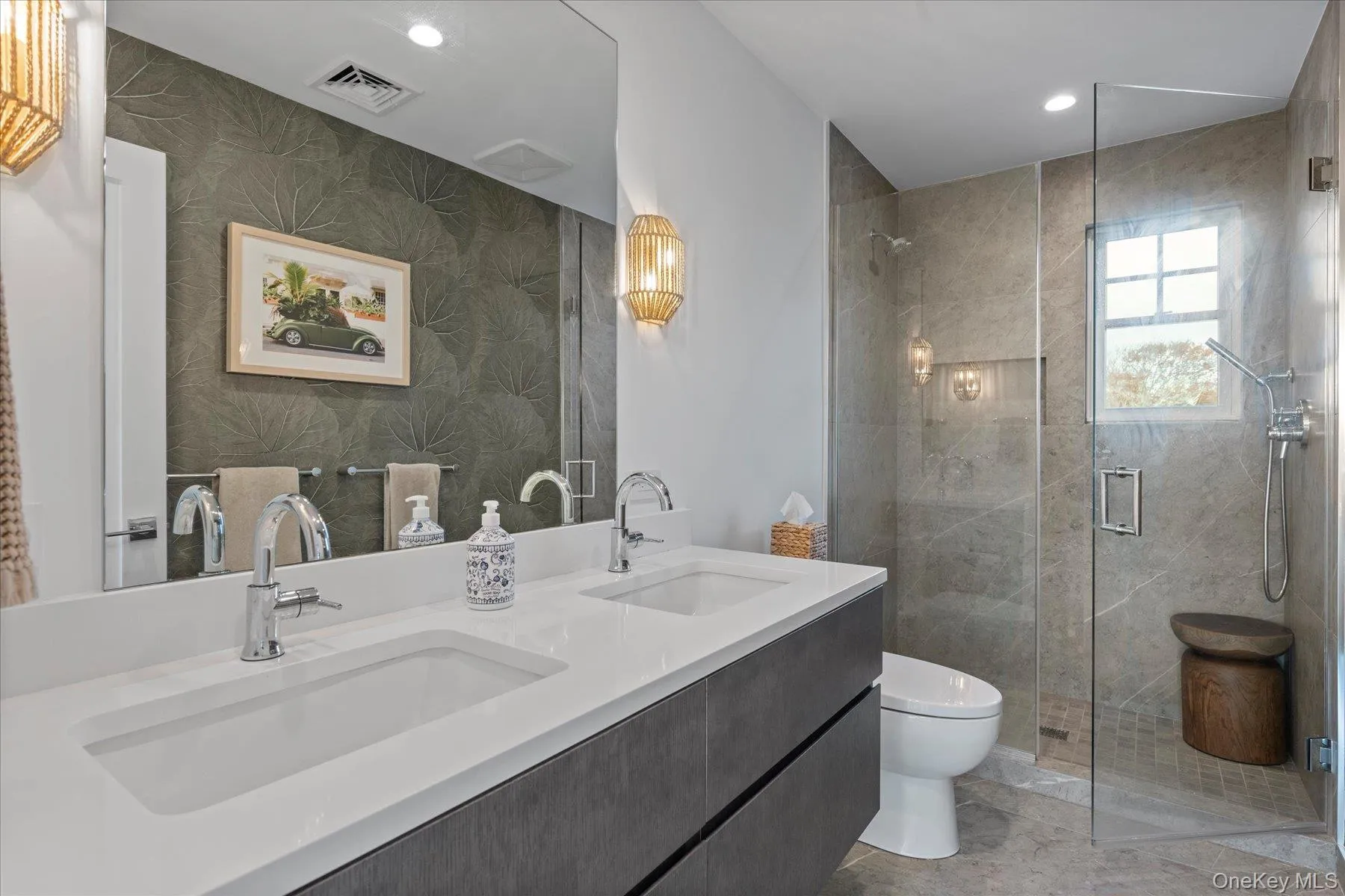 Bathroom featuring double vanity, a stall shower, recessed lighting, and wallpapered walls Bathroom featuring double vanity, a stall shower, recessed lighting, and wallpapered walls