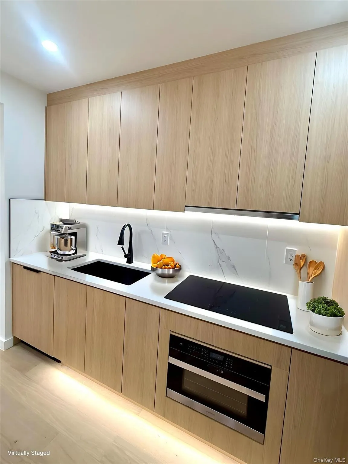 Kitchen featuring modern cabinets, oven, black electric cooktop, and backsplash Kitchen featuring modern cabinets, oven, black electric cooktop, and backsplash