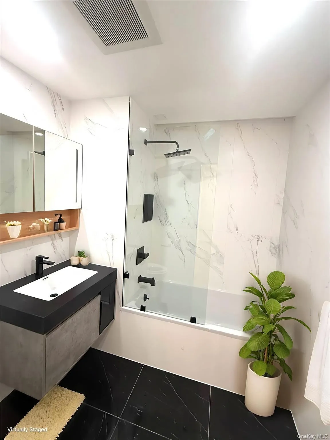 Full bathroom featuring a combined bath / shower with marble appearance, vanity, stone wall, and tile walls Full bathroom featuring a combined bath / shower with marble appearance, vanity, stone wall, and tile walls