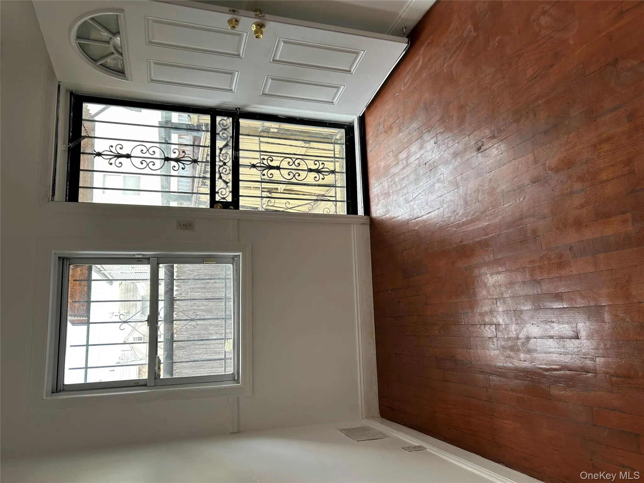Foyer entrance with healthy amount of natural light and dark wood-type flooring Foyer entrance with healthy amount of natural light and dark wood-type flooring