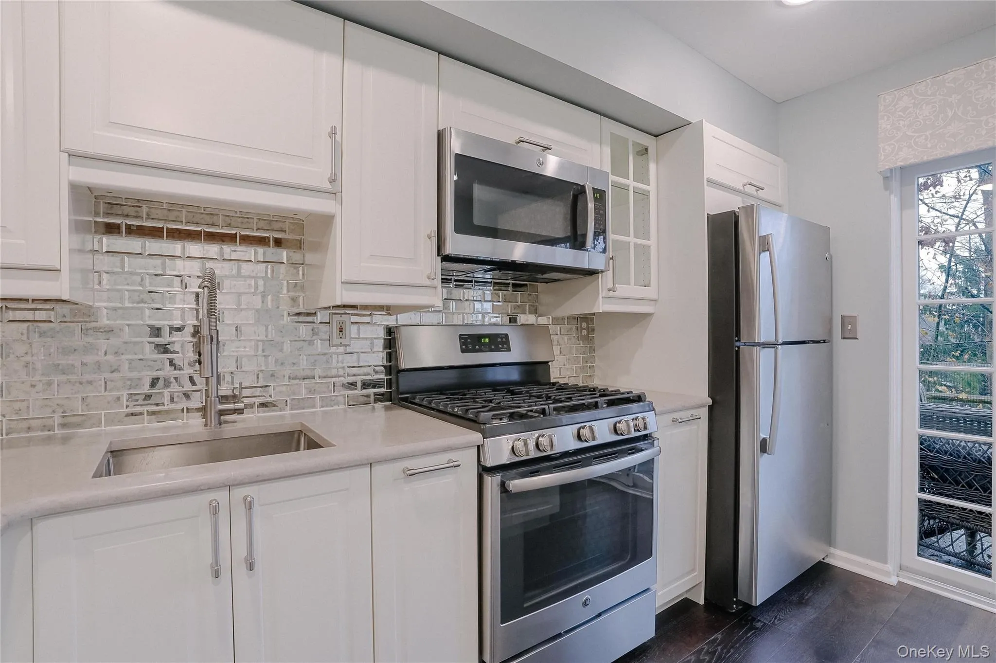 Kitchen with stainless steel appliances and white cabinets Kitchen with stainless steel appliances and white cabinets