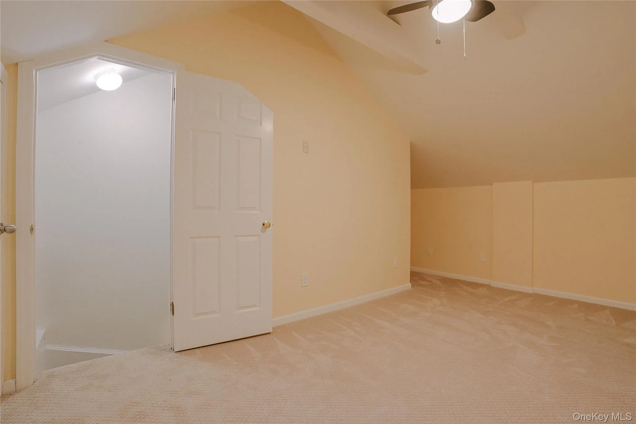 Additional living space with lofted ceiling, carpet floors, and a ceiling fan Additional living space with lofted ceiling, carpet floors, and a ceiling fan