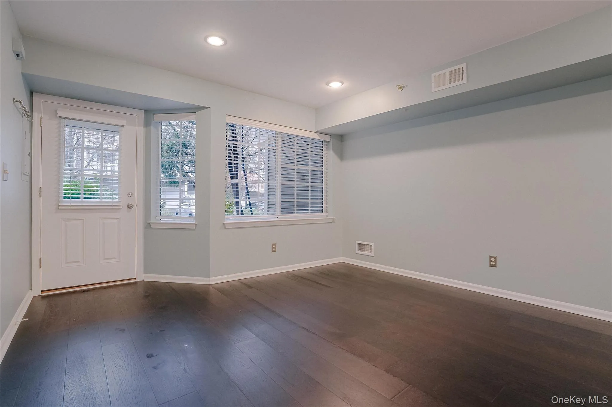 Entry foyer. Unfurnished room featuring plenty of natural light, dark wood-style floors, and recessed lighting Entry foyer. Unfurnished room featuring plenty of natural light, dark wood-style floors, and recessed lighting