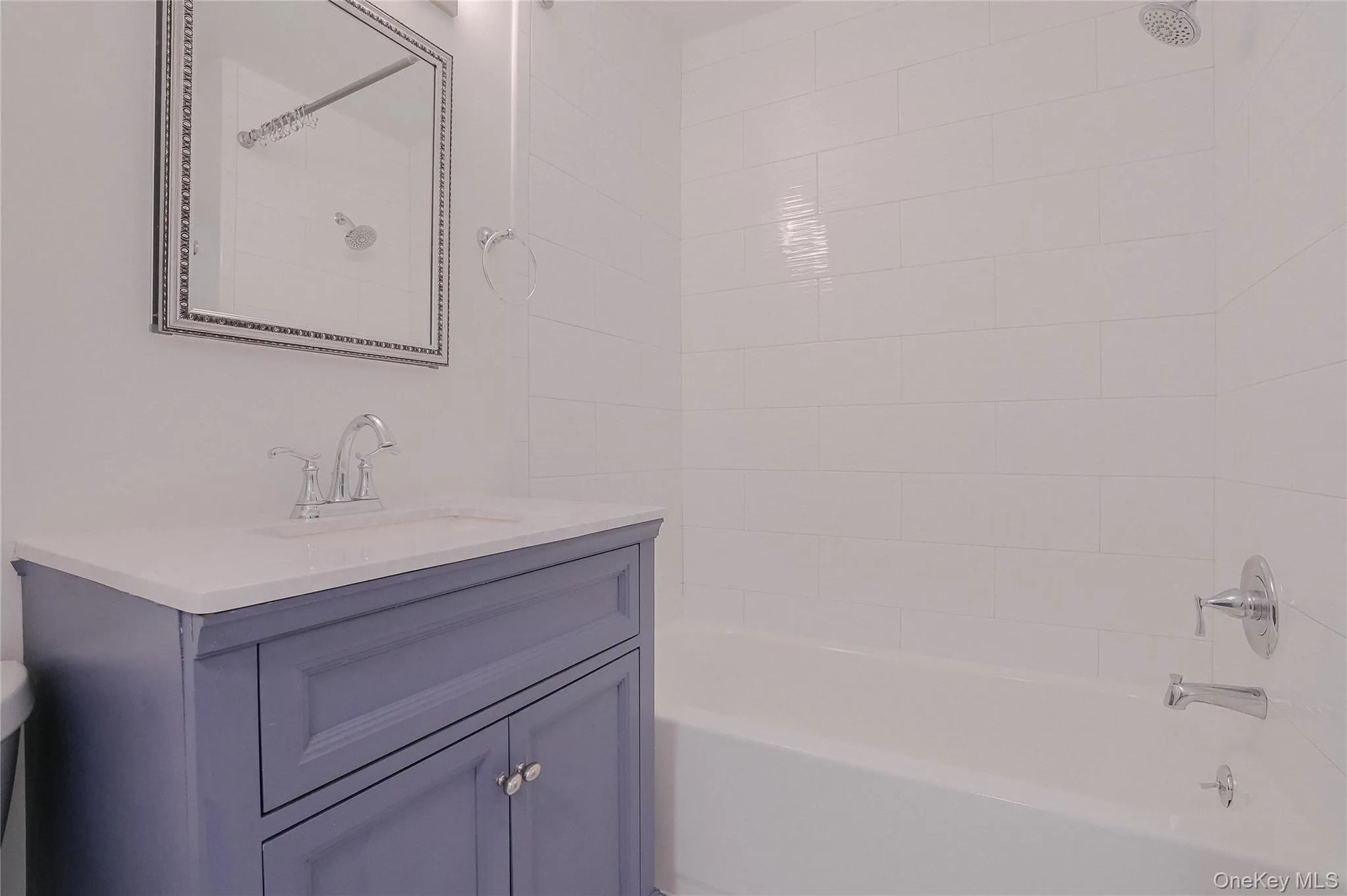 Bathroom with vanity and bathing tub / shower combination Bathroom with vanity and bathing tub / shower combination