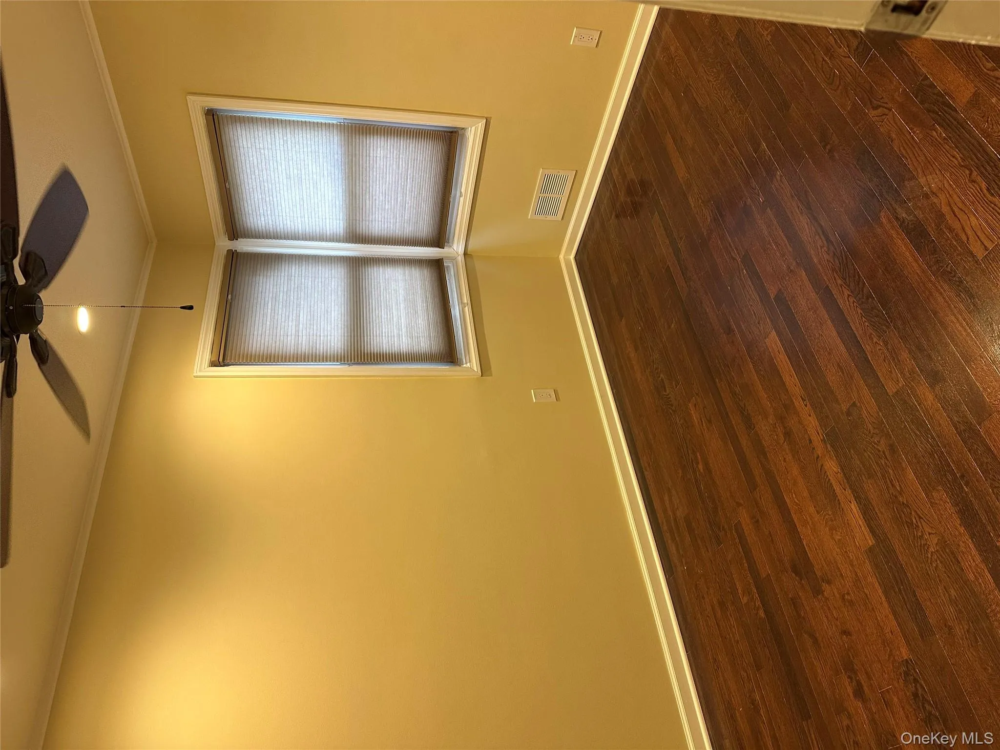 Unfurnished room with dark wood-style floors, ornamental molding, a ceiling fan, and recessed lighting Unfurnished room with dark wood-style floors, ornamental molding, a ceiling fan, and recessed lighting