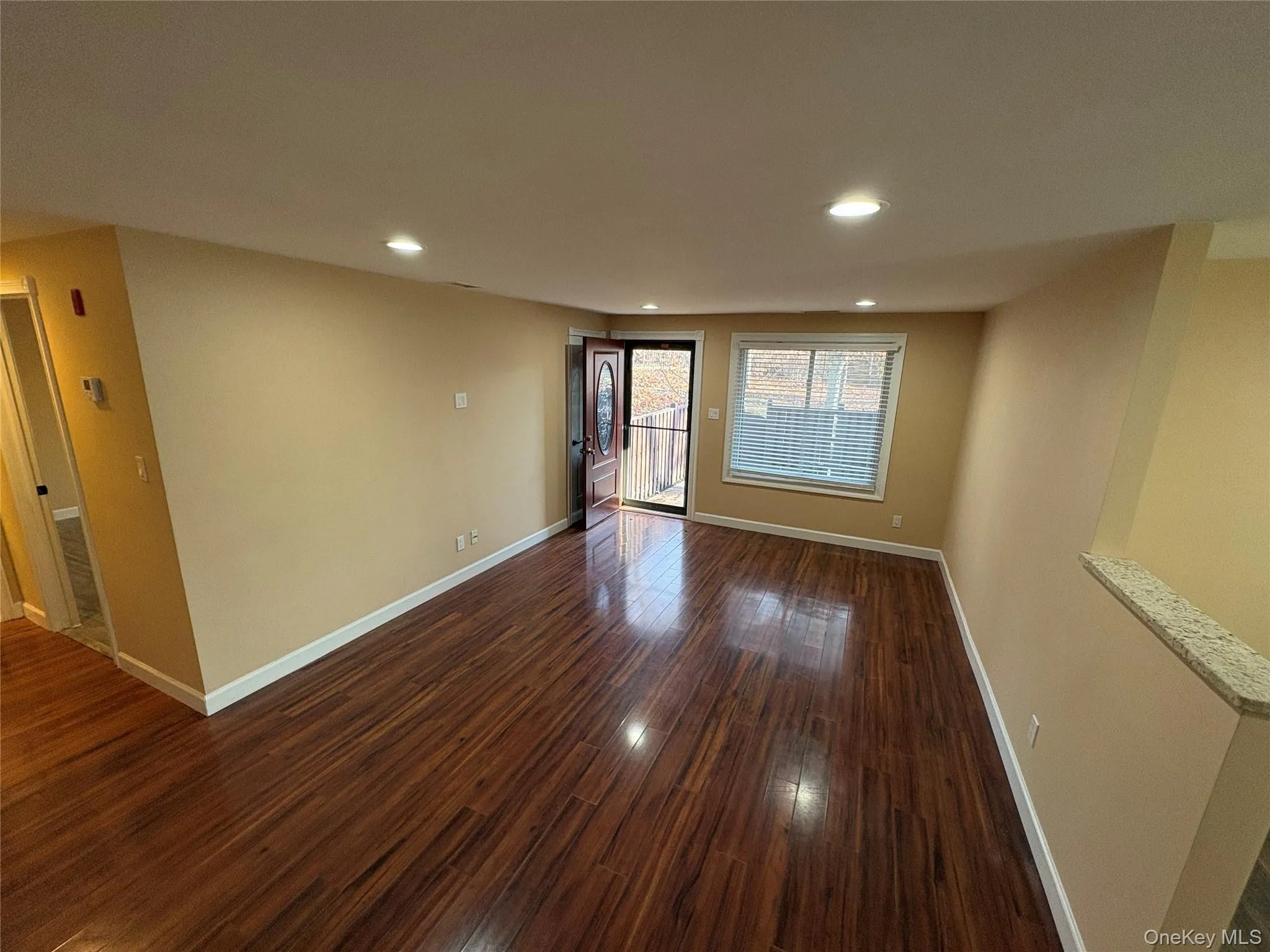 Empty room featuring dark wood finished floors and recessed lighting Empty room featuring dark wood finished floors and recessed lighting