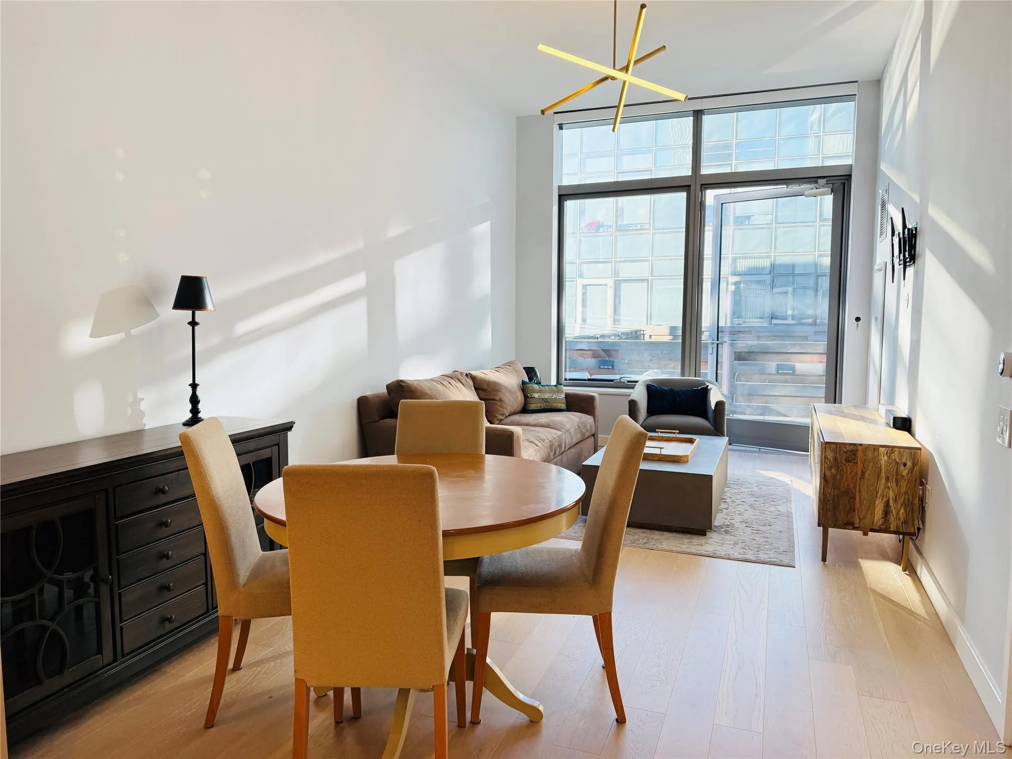 Dining room featuring light wood finished floors and expansive windows Dining room featuring light wood finished floors and expansive windows