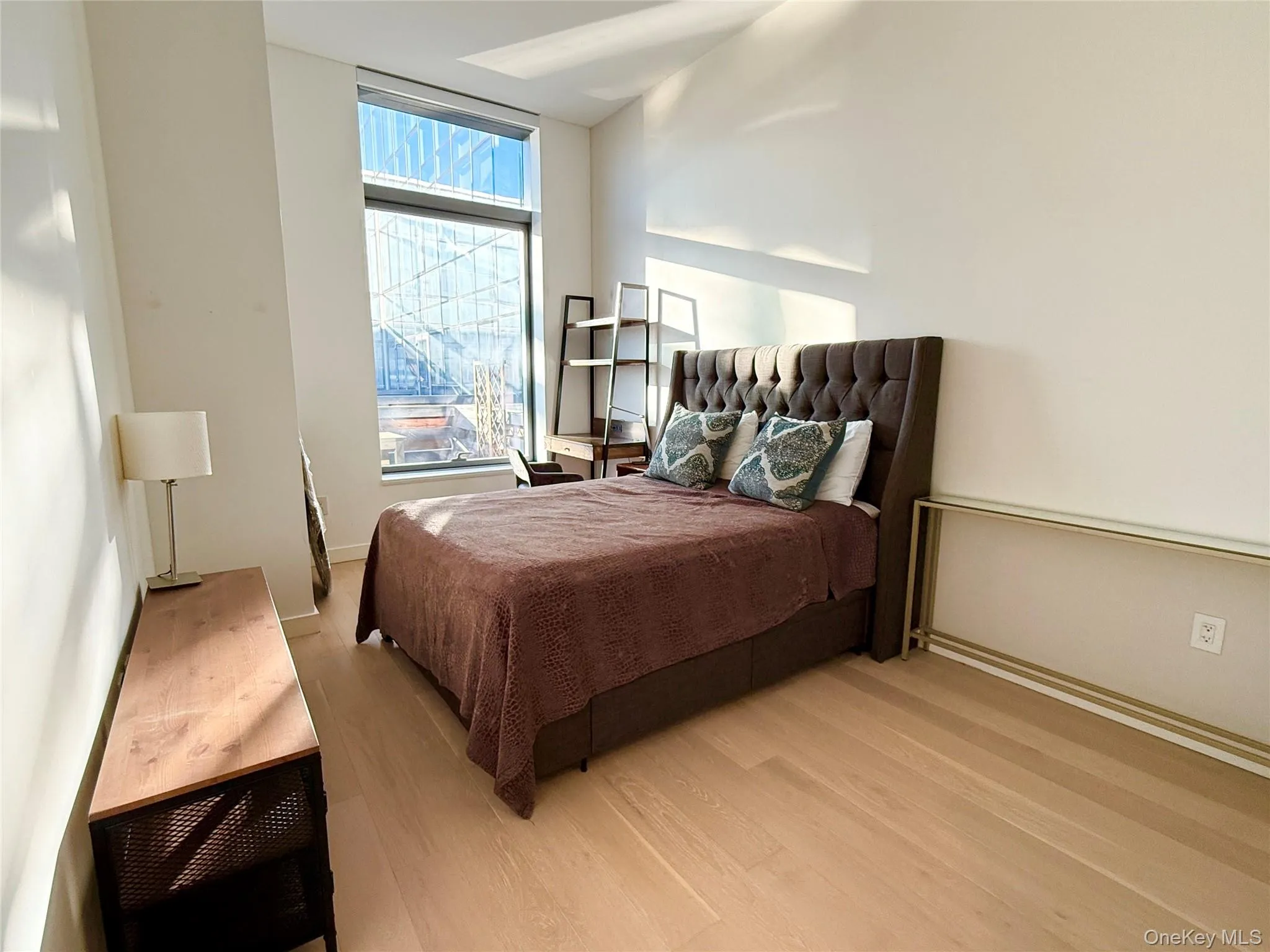 Bedroom featuring wood finished floors and baseboards Bedroom featuring wood finished floors and baseboards
