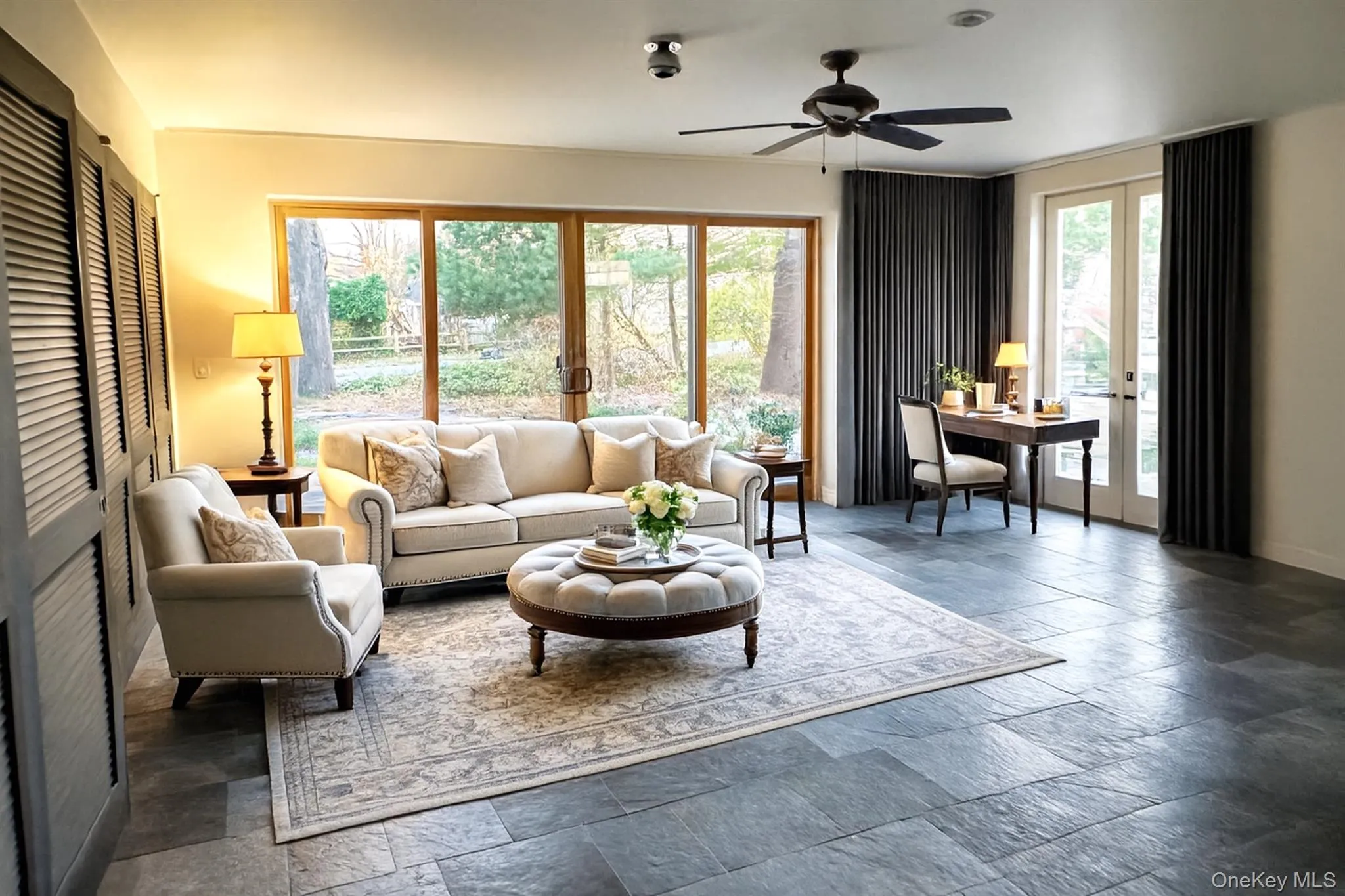 Living area featuring french doors, slate tile flooring, ceiling fan, Living area featuring french doors, slate tile flooring, ceiling fan,