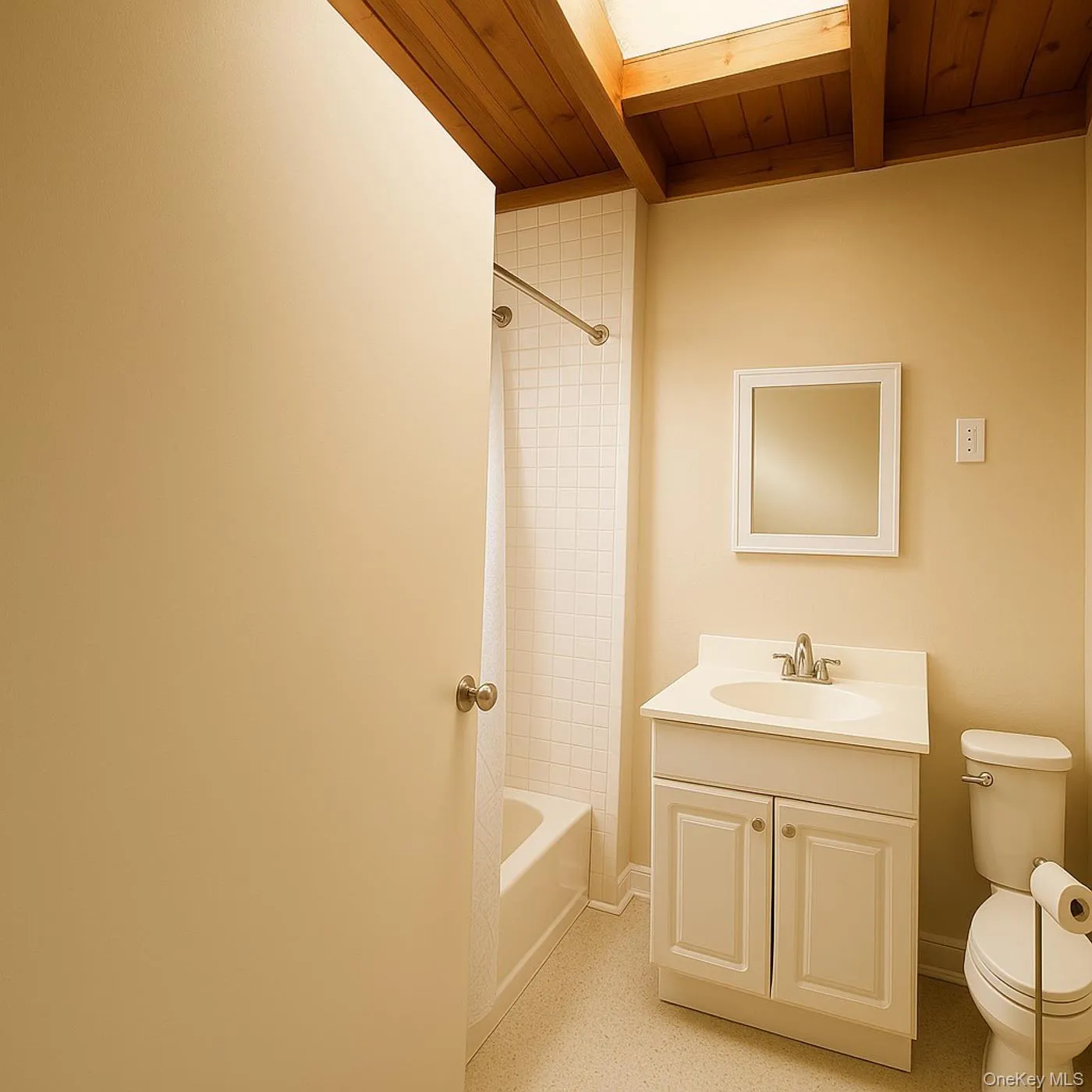 Full bath featuring vanity, a wood ceiling with exposed beams, and shower / bath combination with curtain Full bath featuring vanity, a wood ceiling with exposed beams, and shower / bath combination with curtain
