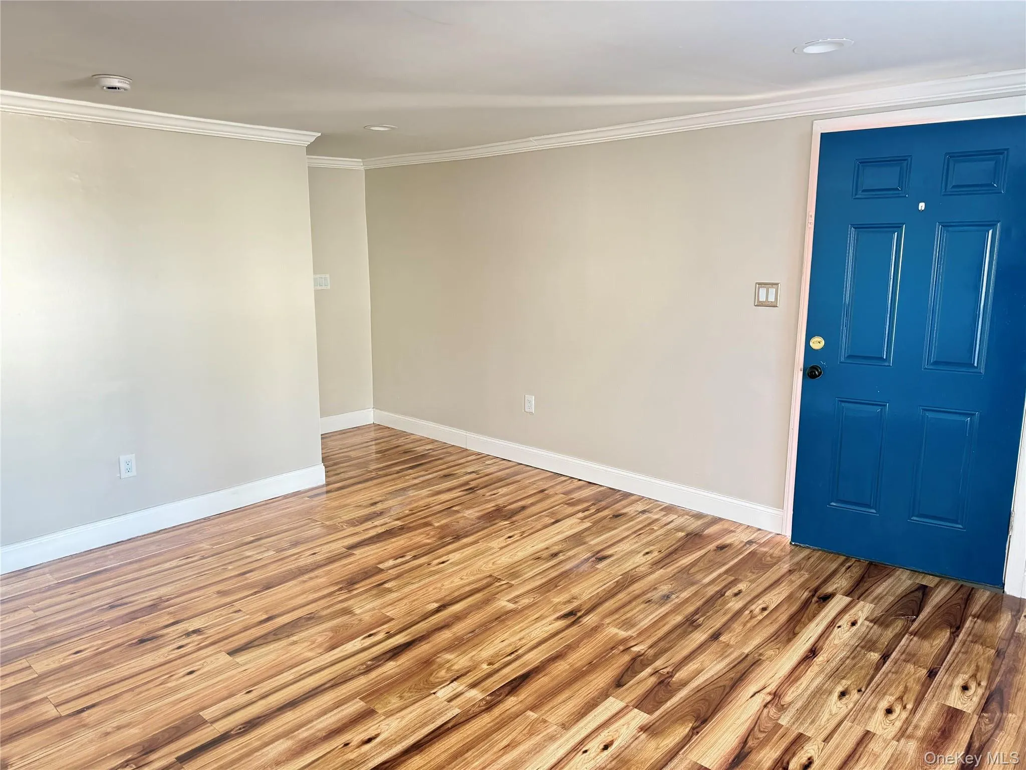 Unfurnished room featuring wood finished floors, crown molding, and recessed lighting Unfurnished room featuring wood finished floors, crown molding, and recessed lighting