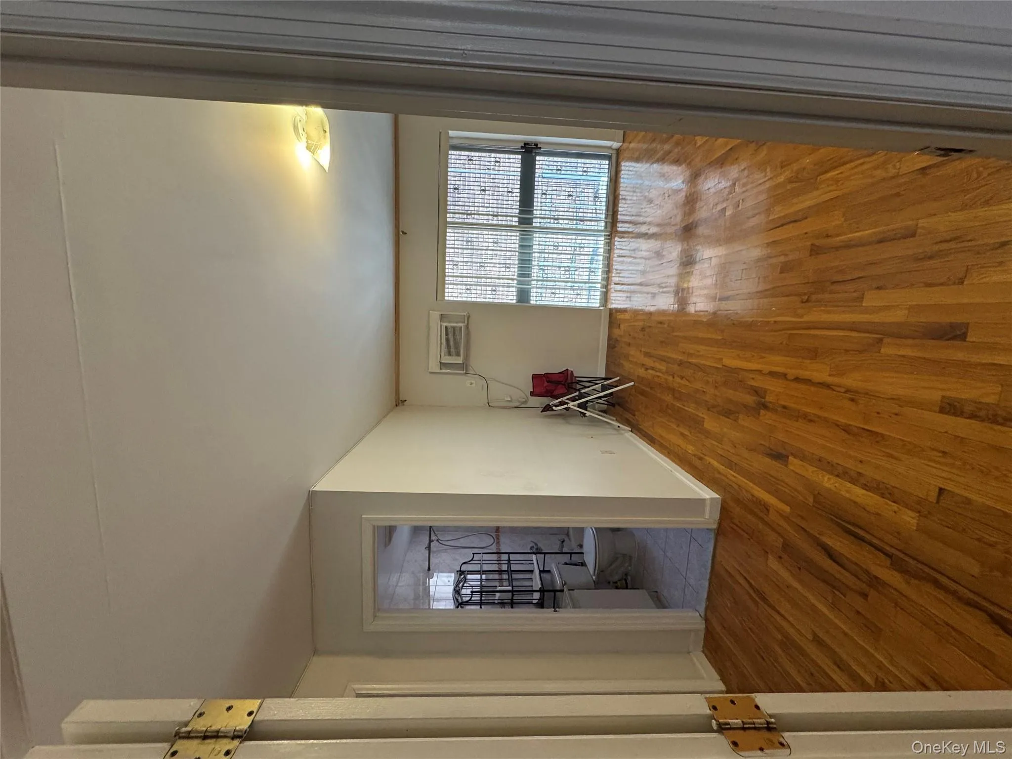 Spare room with light wood-type flooring and a wall unit AC Spare room with light wood-type flooring and a wall unit AC