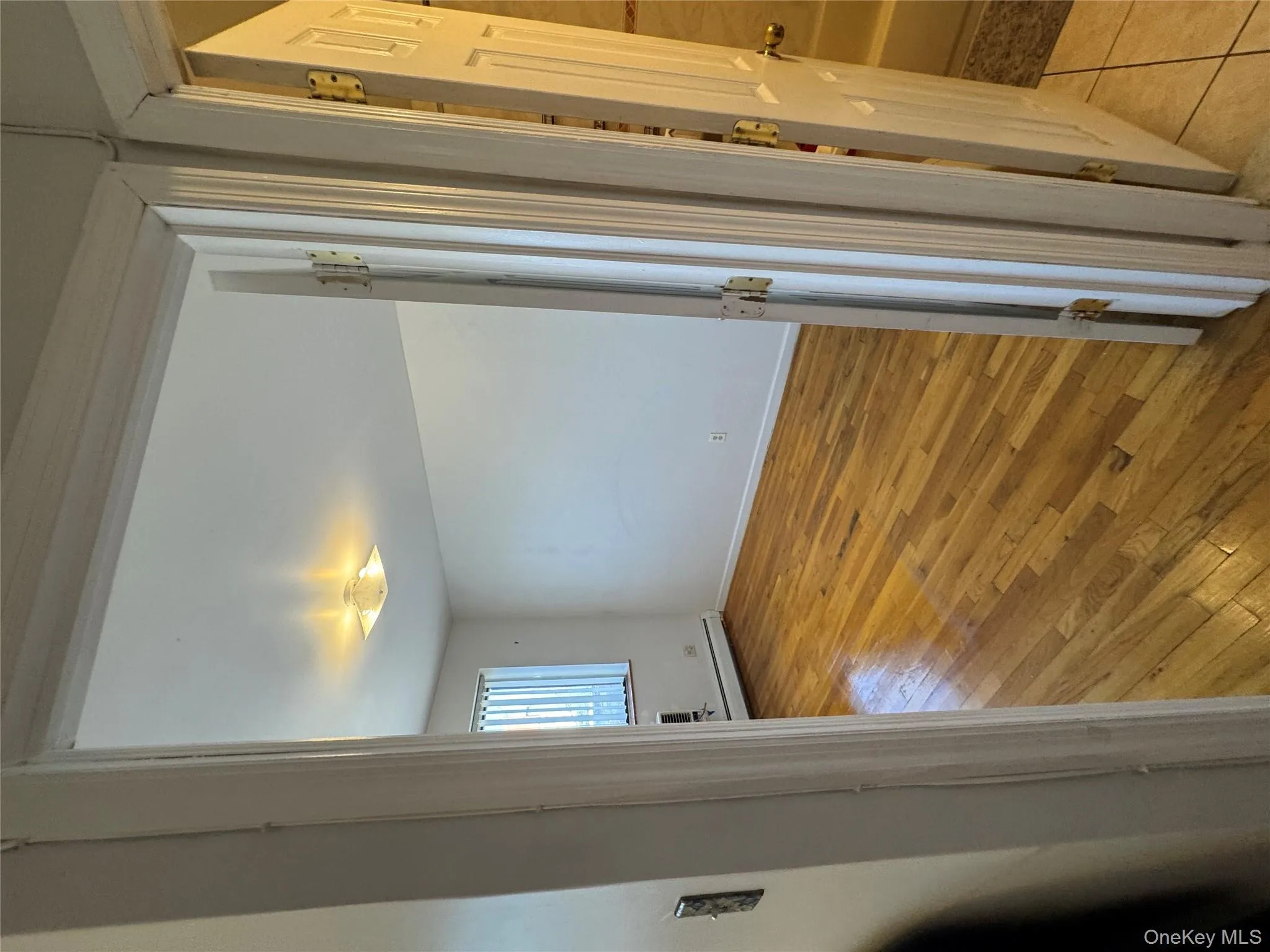Empty room featuring light wood-style flooring and baseboard heating Empty room featuring light wood-style flooring and baseboard heating