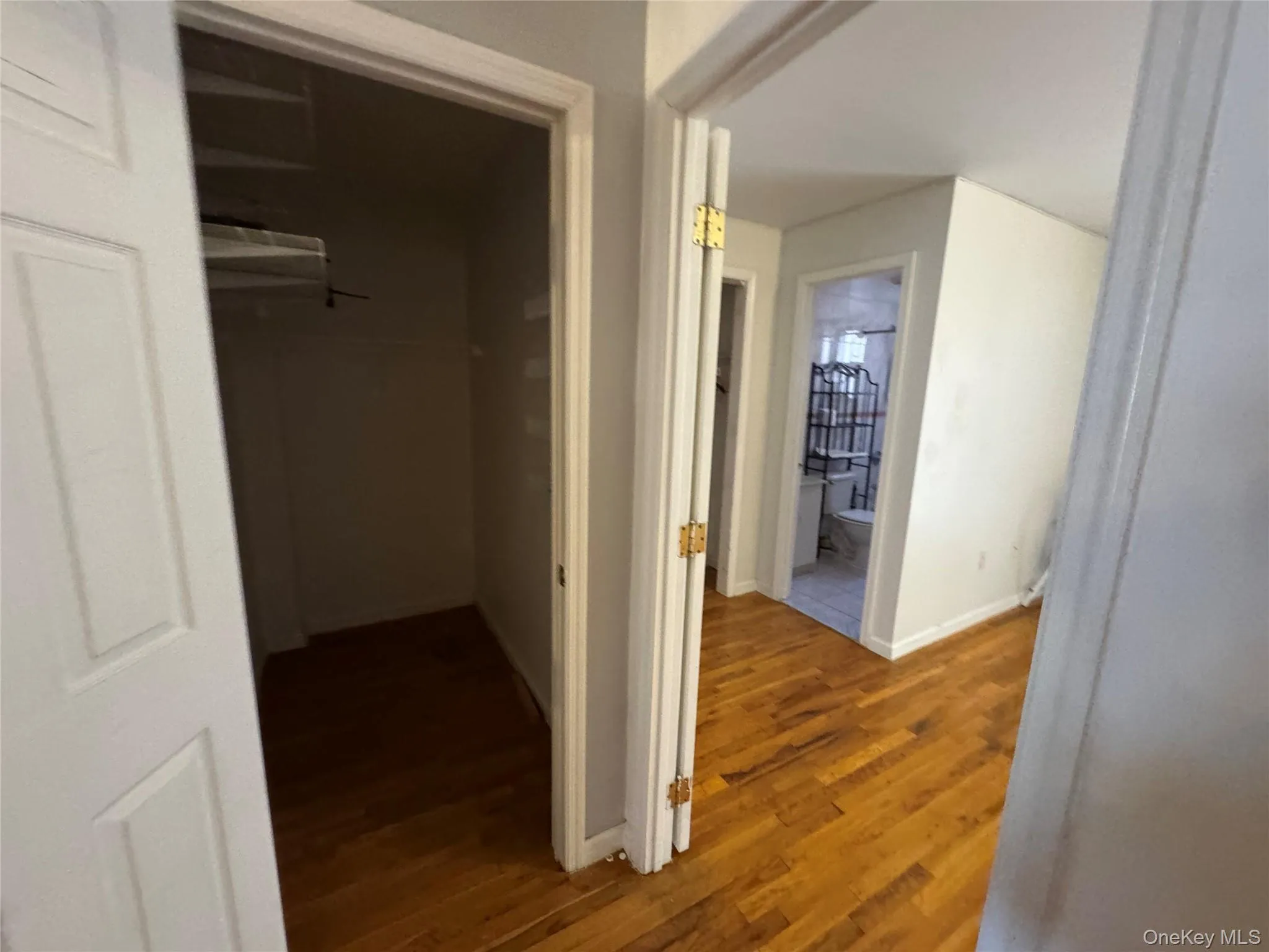Hallway featuring wood finished floors and baseboards Hallway featuring wood finished floors and baseboards
