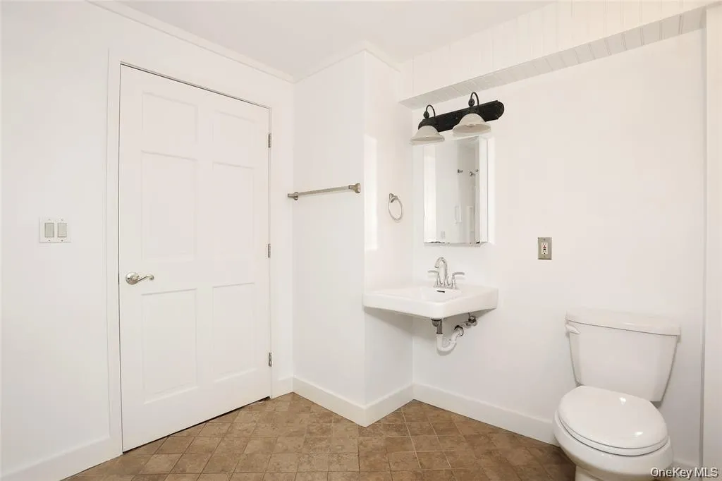 Bathroom with toilet and baseboards Bathroom with toilet and baseboards