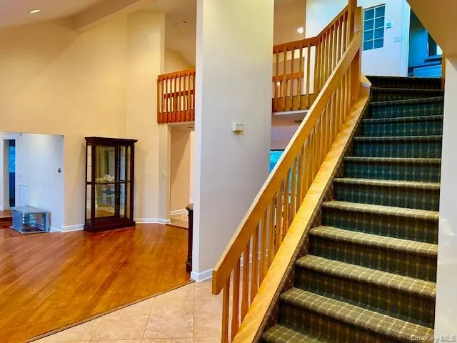 Stairs with wood finished floors and a high ceiling Stairs with wood finished floors and a high ceiling