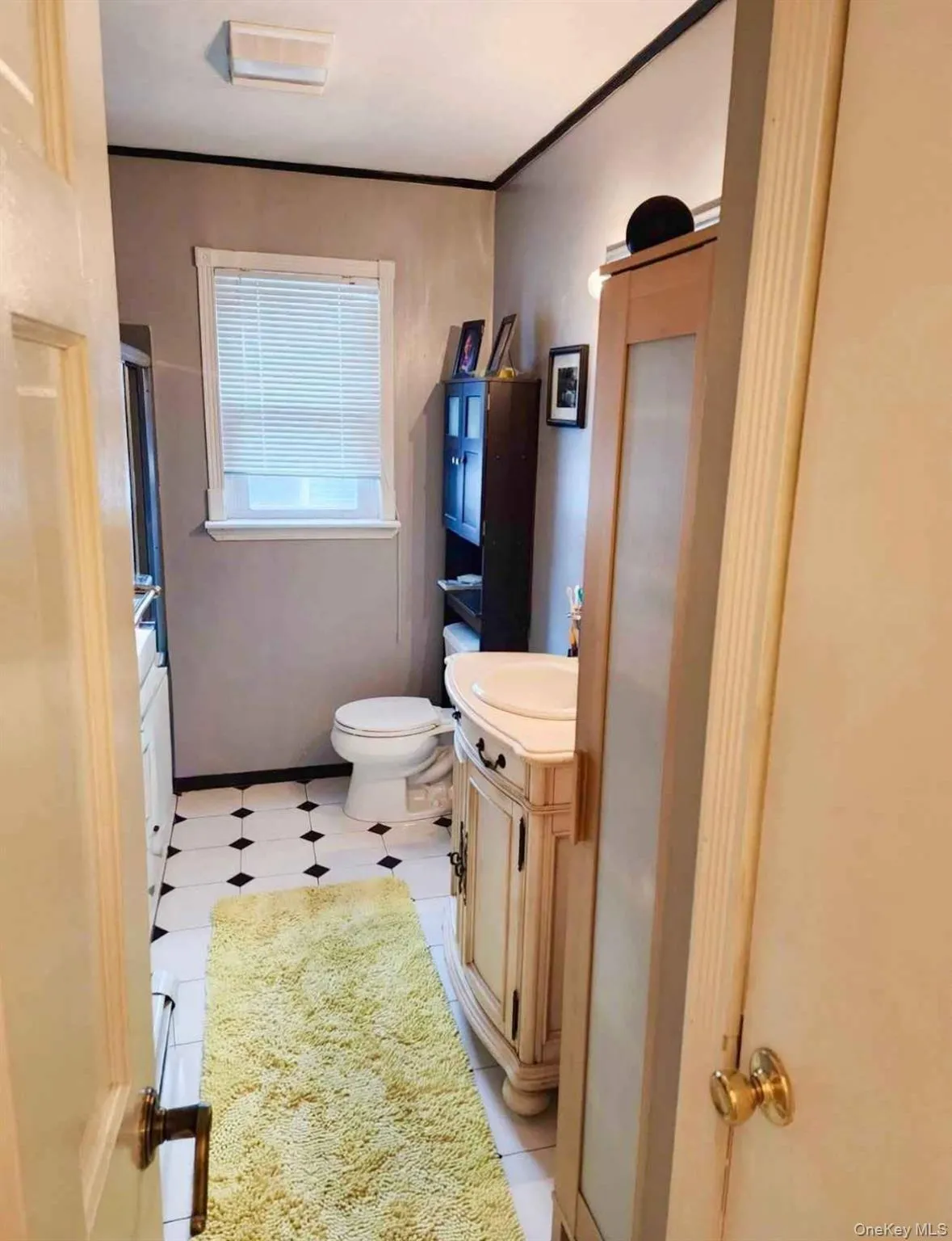Bathroom featuring vanity, crown molding, and an enclosed shower Bathroom featuring vanity, crown molding, and an enclosed shower