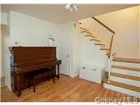 Sitting room featuring stairway and light wood-style flooring Sitting room featuring stairway and light wood-style flooring