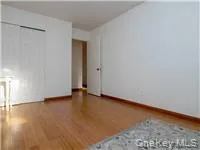 Unfurnished bedroom featuring a closet and wood finished floors Unfurnished bedroom featuring a closet and wood finished floors