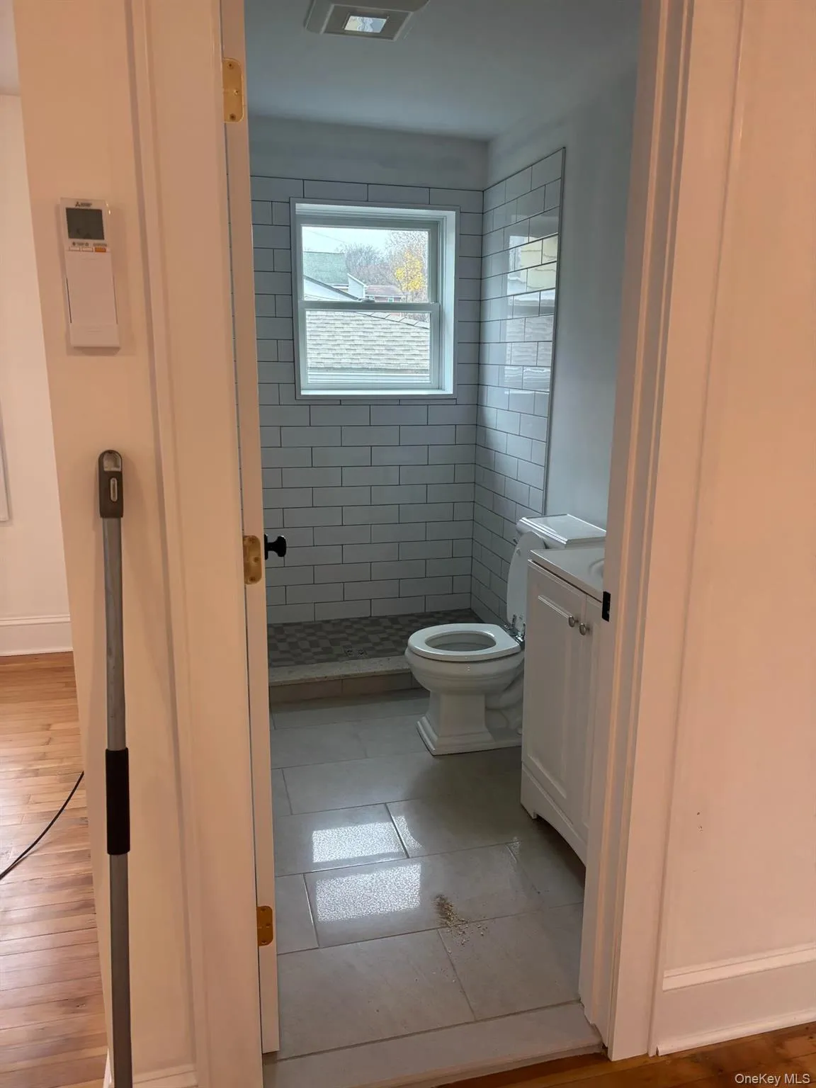 Bathroom featuring a stall shower, vanity, and light tile patterned floors Bathroom featuring a stall shower, vanity, and light tile patterned floors