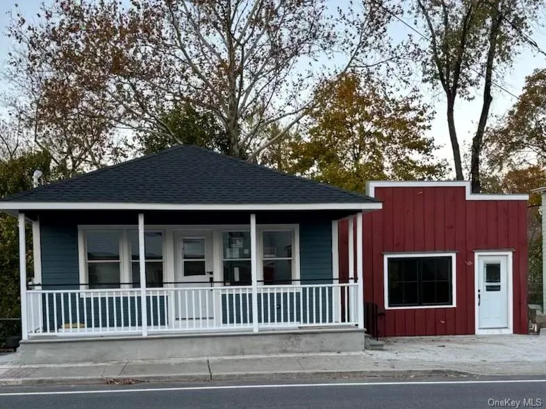 View of front of house with covered porch, a shingled roof, and board and batten siding View of front of house with covered porch, a shingled roof, and board and batten siding