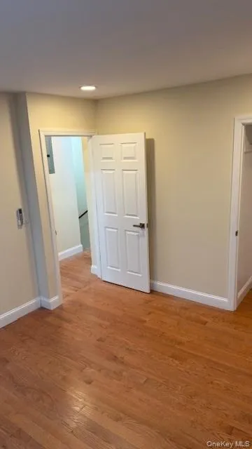 Spare room with baseboards and light wood finished floors Spare room with baseboards and light wood finished floors