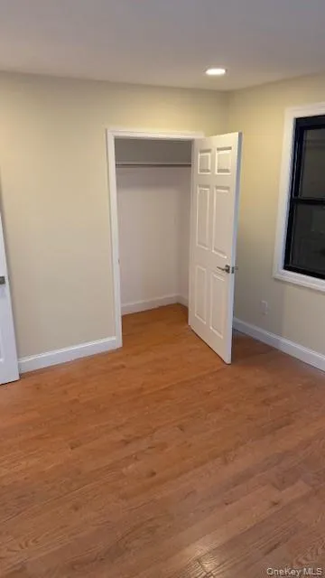 Unfurnished bedroom featuring light wood-style flooring and a closet Unfurnished bedroom featuring light wood-style flooring and a closet