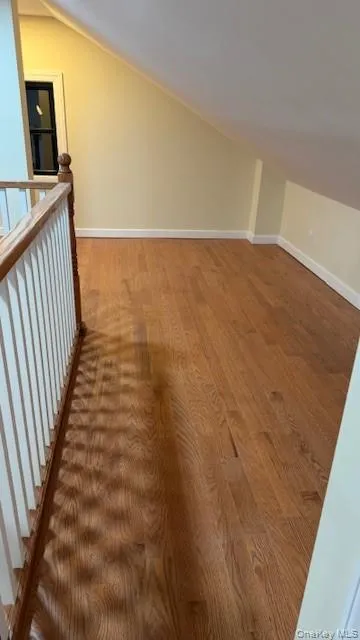 Additional living space with vaulted ceiling and wood finished floors Additional living space with vaulted ceiling and wood finished floors