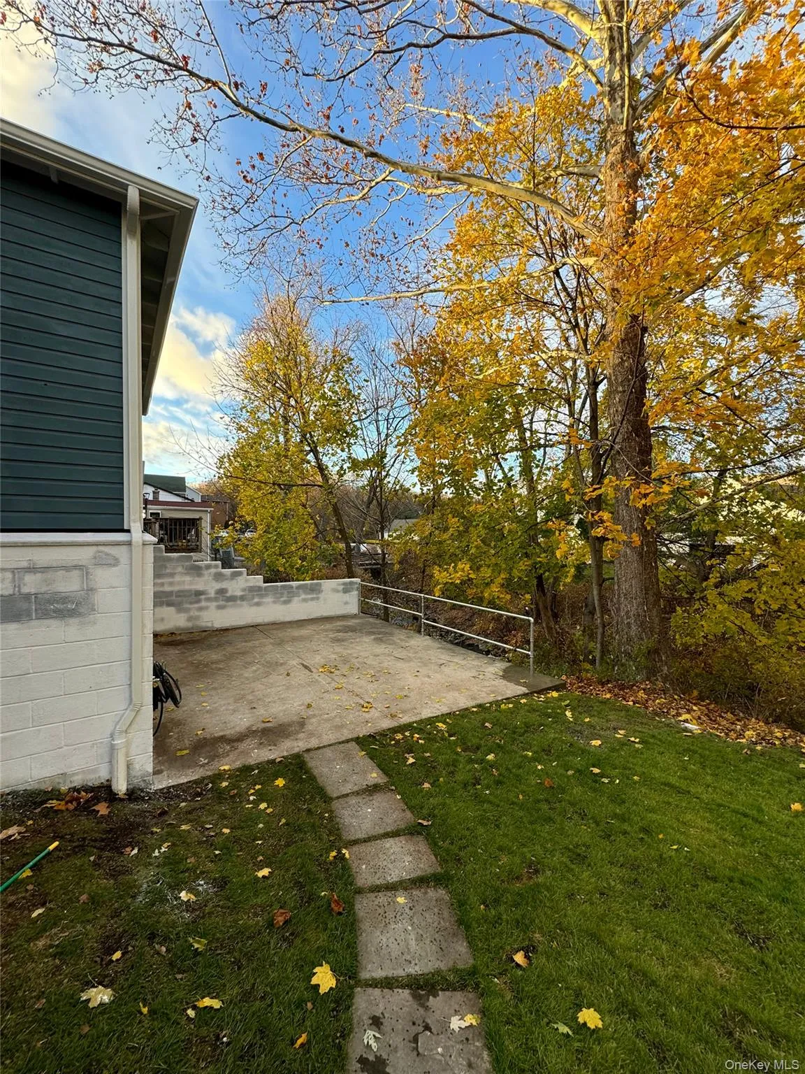 View of green lawn with a patio View of green lawn with a patio