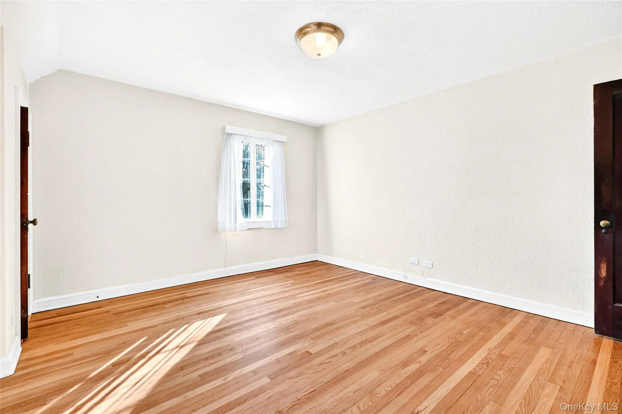 Empty room featuring light wood finished floors Empty room featuring light wood finished floors